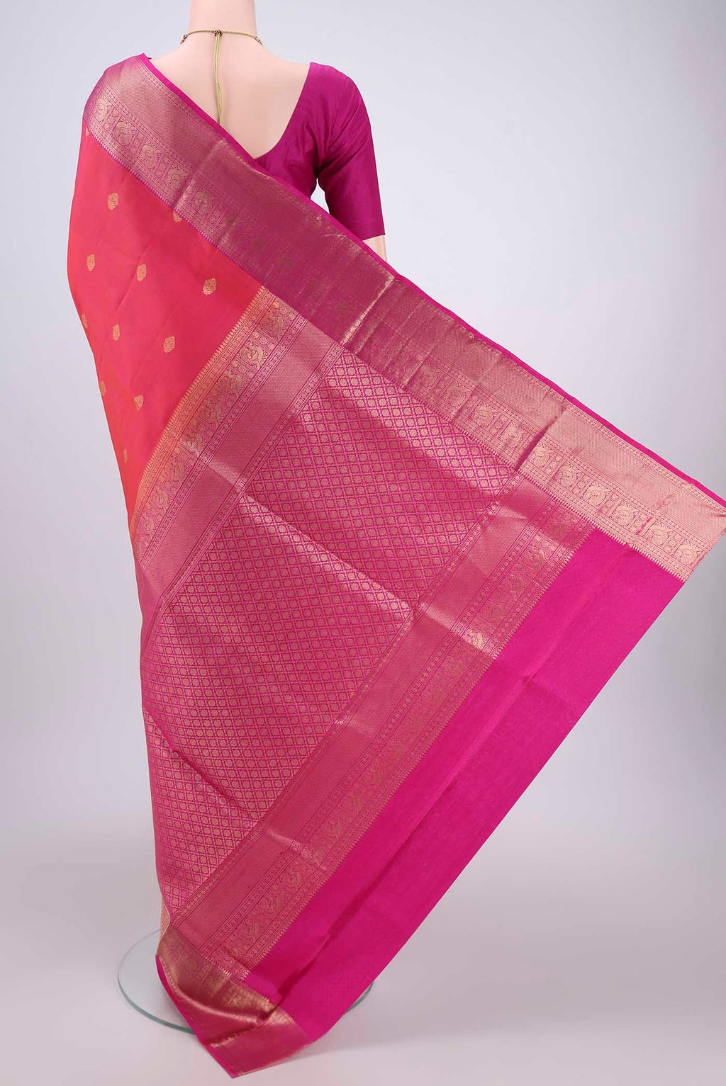 Flat view of Orange Soft Silk Saree with Zari Butta on the body and Zari Border. 