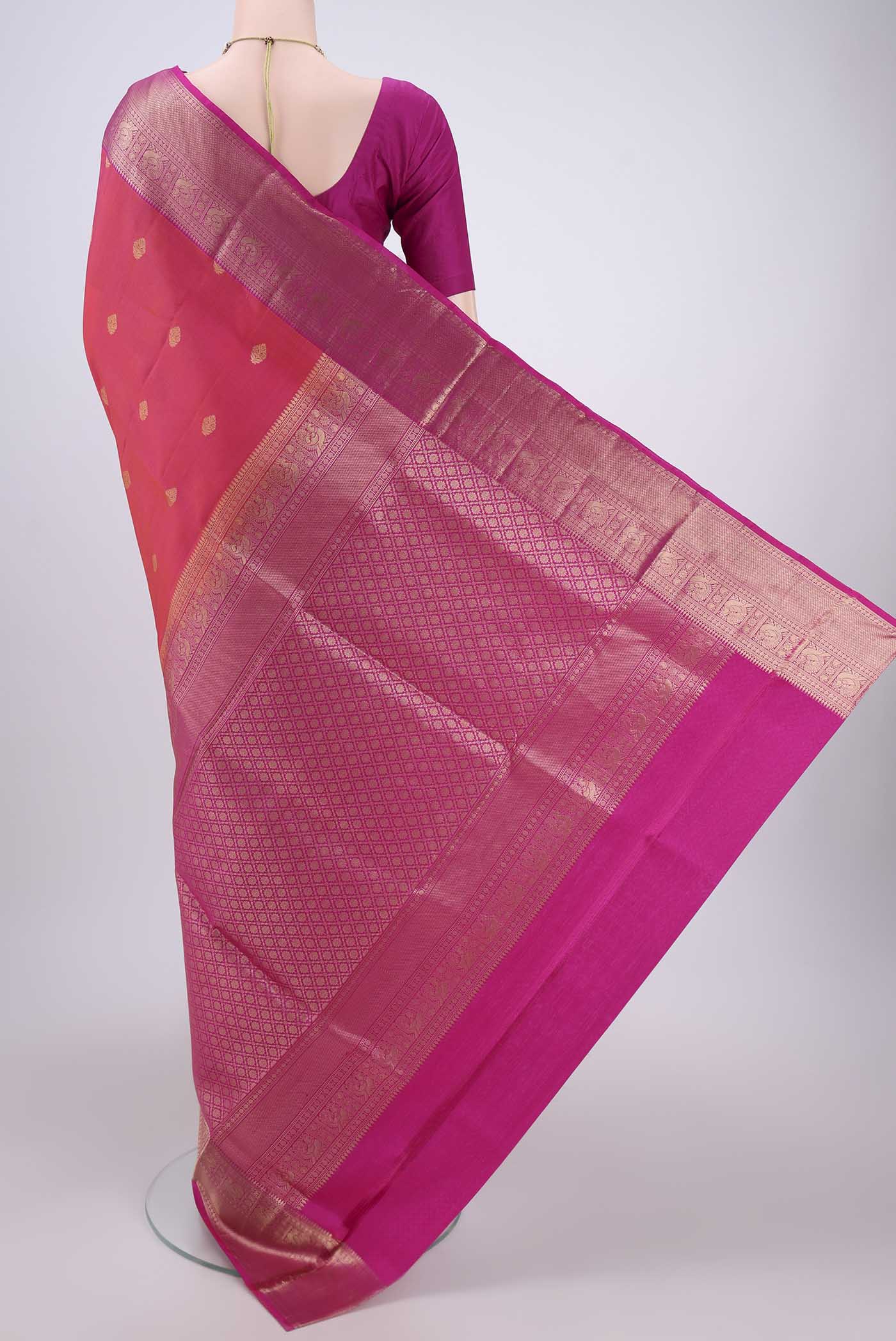 Flat view of Orange Soft Silk Saree with Zari Butta on the body and Zari Border. 