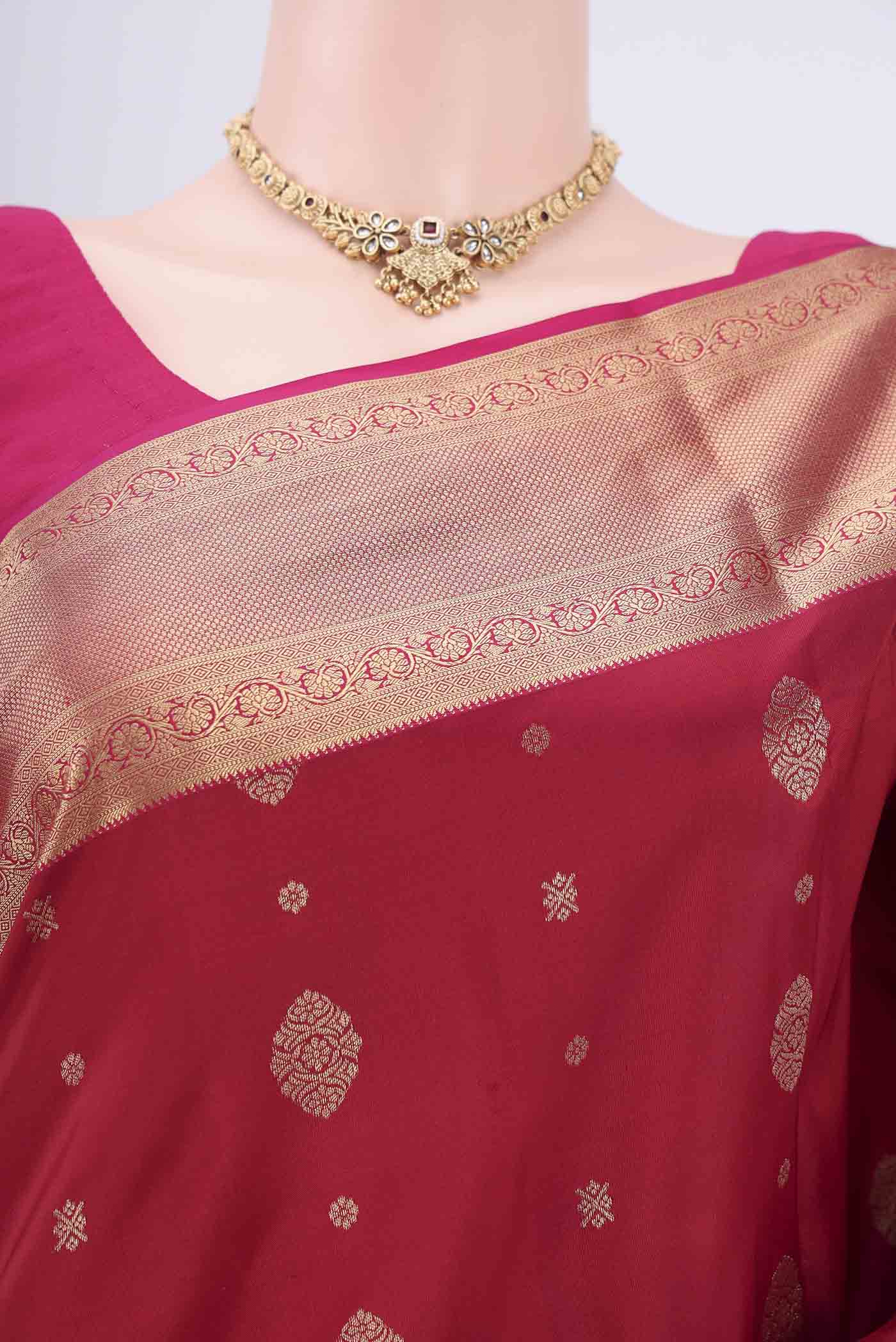 Border image of Maroon Soft Silk Saree with Zari Butta on the body and Zari Border. 