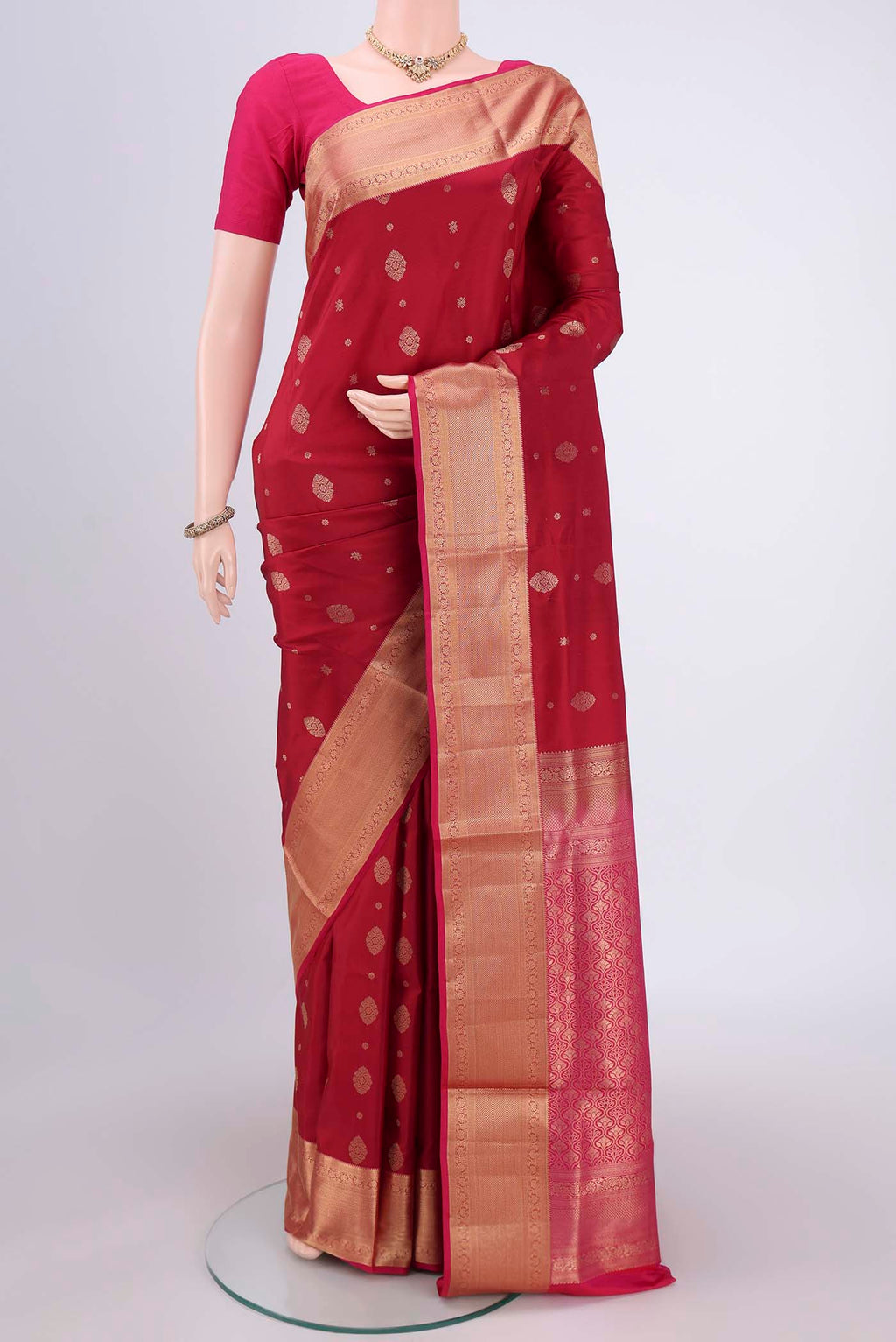 Maroon Soft Silk Saree with Zari Butta on the body and Zari Border.  displayed on a mannequin