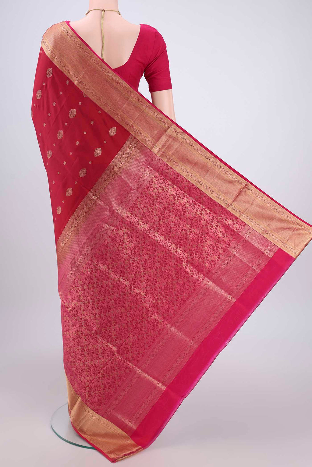 Flat view of Maroon Soft Silk Saree with Zari Butta on the body and Zari Border. 