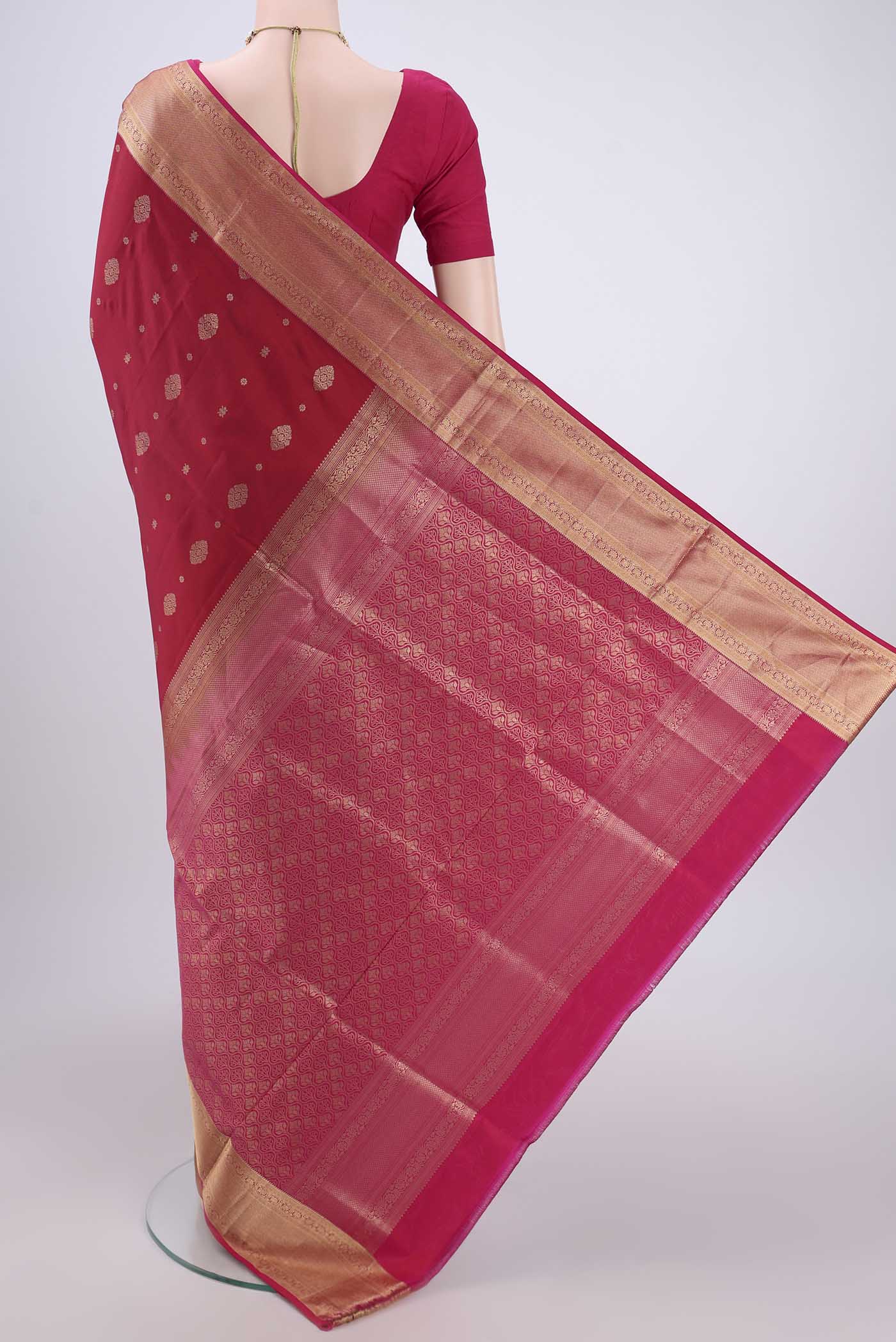 Flat view of Maroon Soft Silk Saree with Zari Butta on the body and Zari Border. 