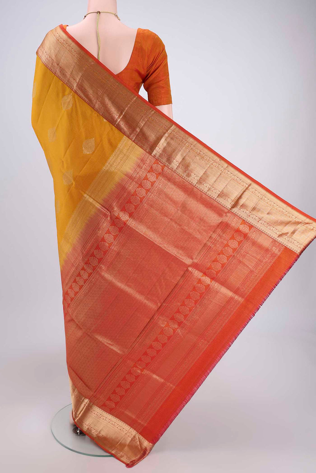 Flat view of Yellow Soft Silk Saree with Zari Butta on the body and Zari Border. 
