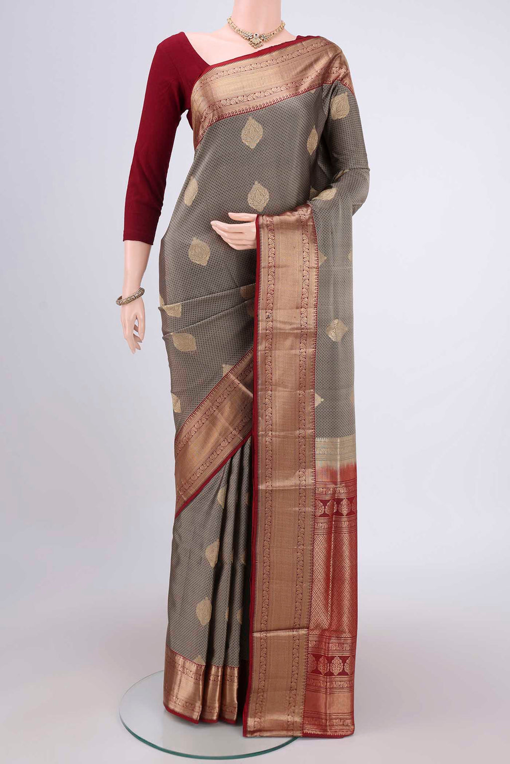 Grey Soft Silk Saree with Zari Butta on the body and Zari Border.  displayed on a mannequin