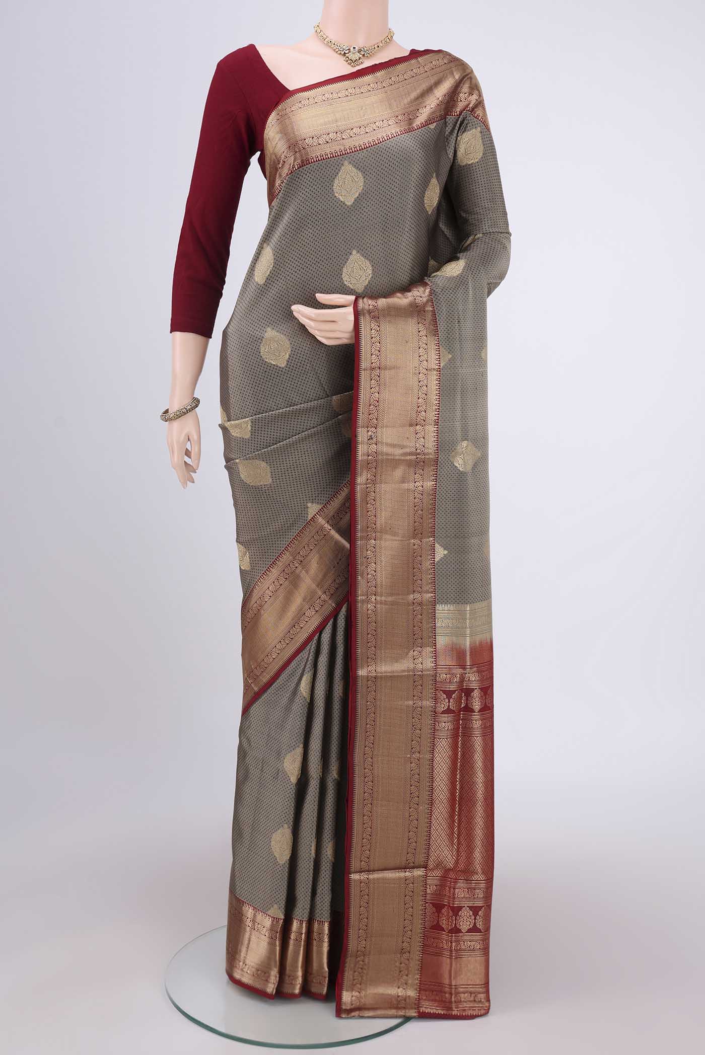 Grey Soft Silk Saree with Zari Butta on the body and Zari Border.  displayed on a mannequin