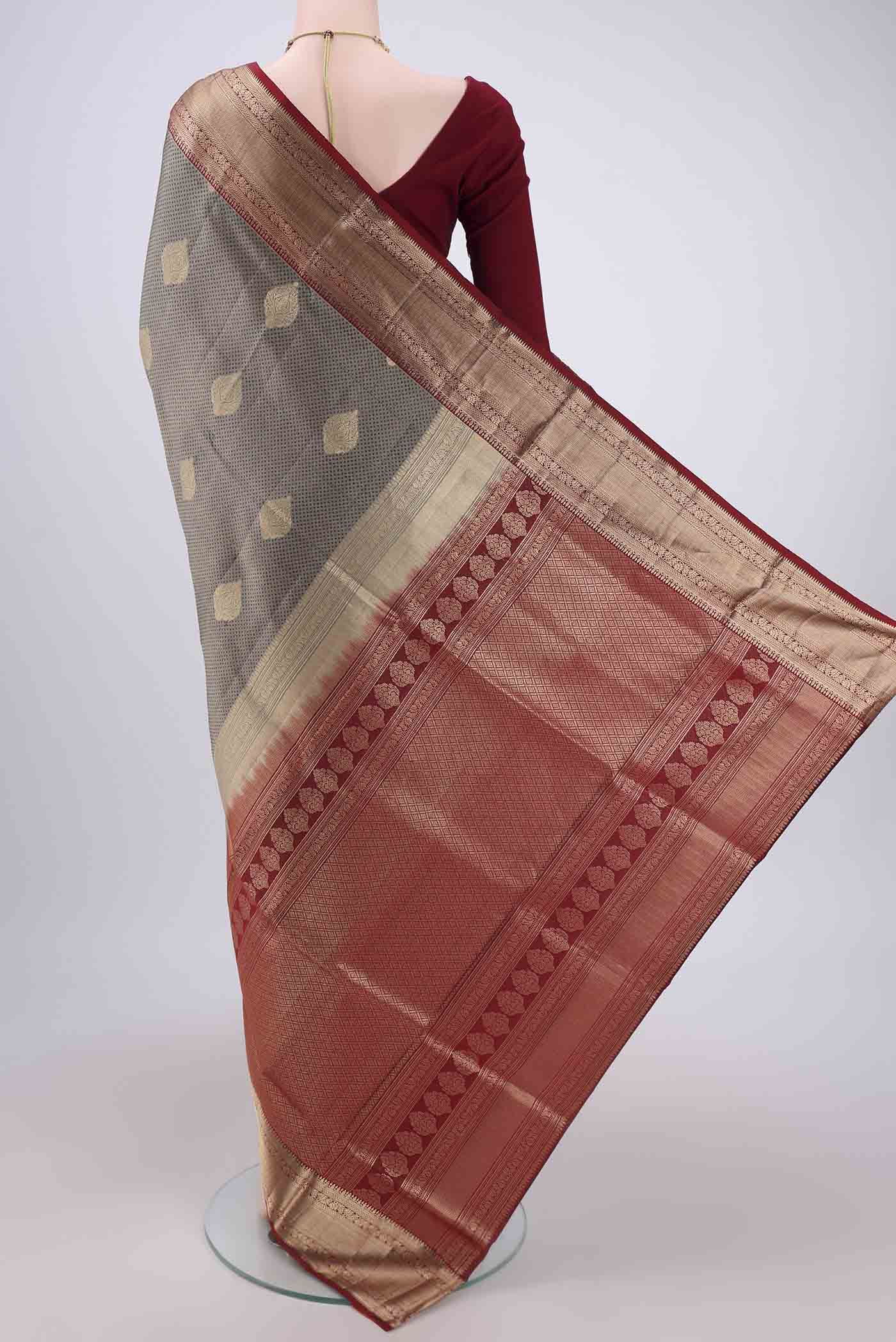 Flat view of Grey Soft Silk Saree with Zari Butta on the body and Zari Border. 