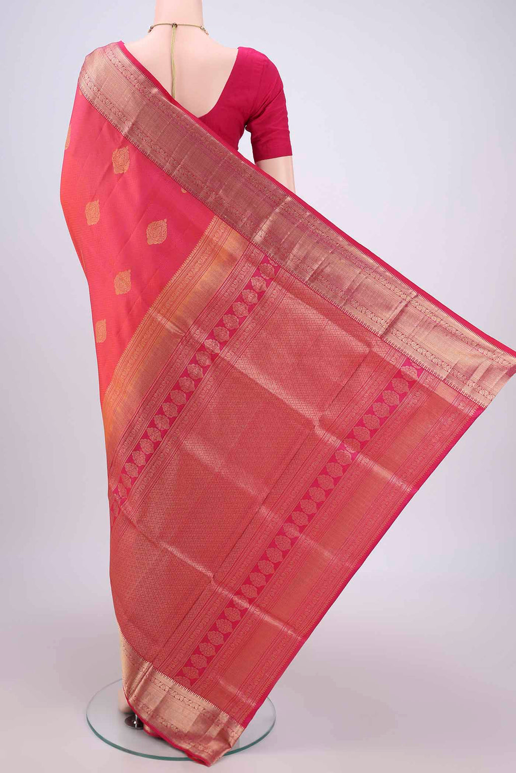 Flat view of Pink Soft Silk Saree with Zari Butta on the body and Zari Border. 