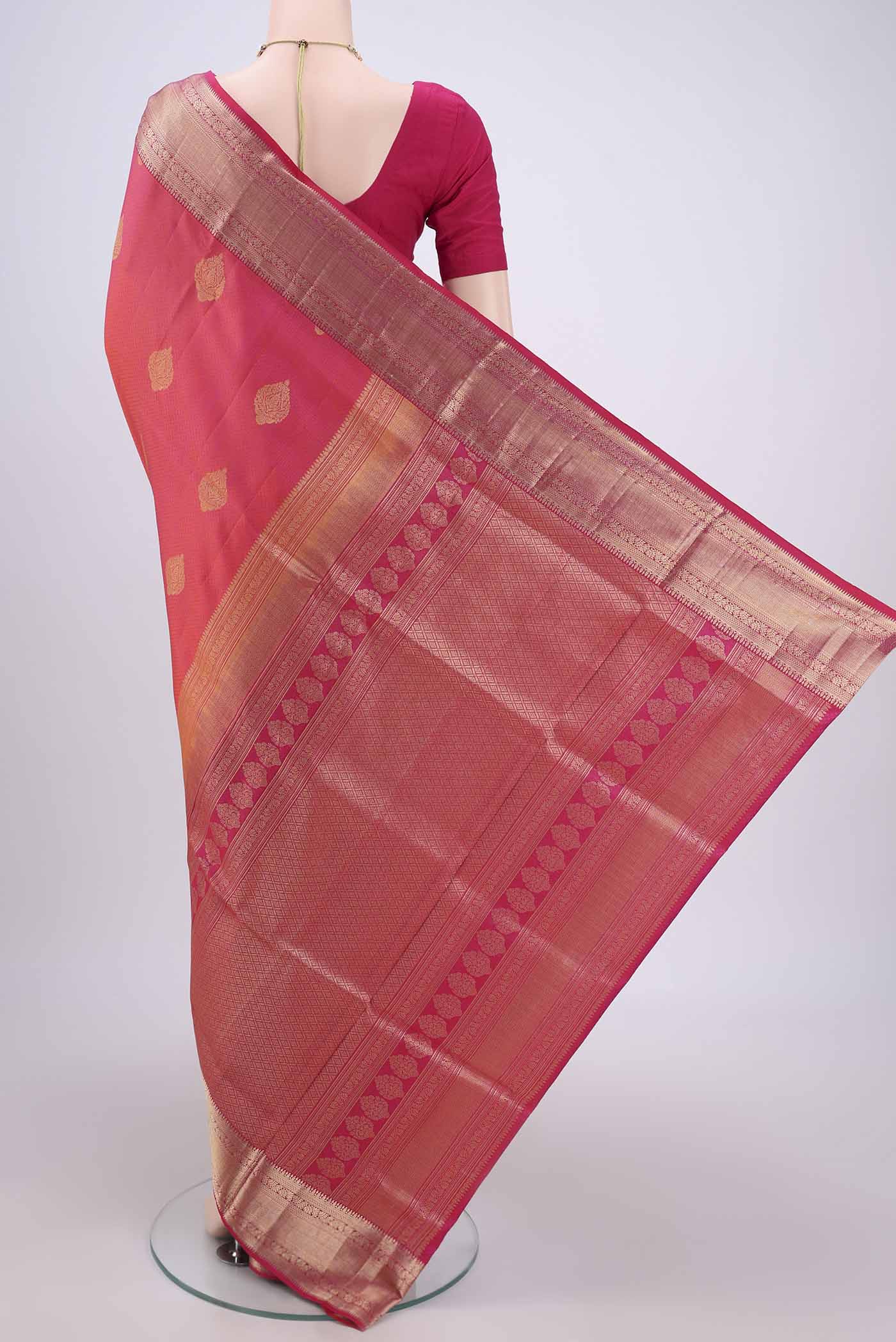 Flat view of Pink Soft Silk Saree with Zari Butta on the body and Zari Border. 