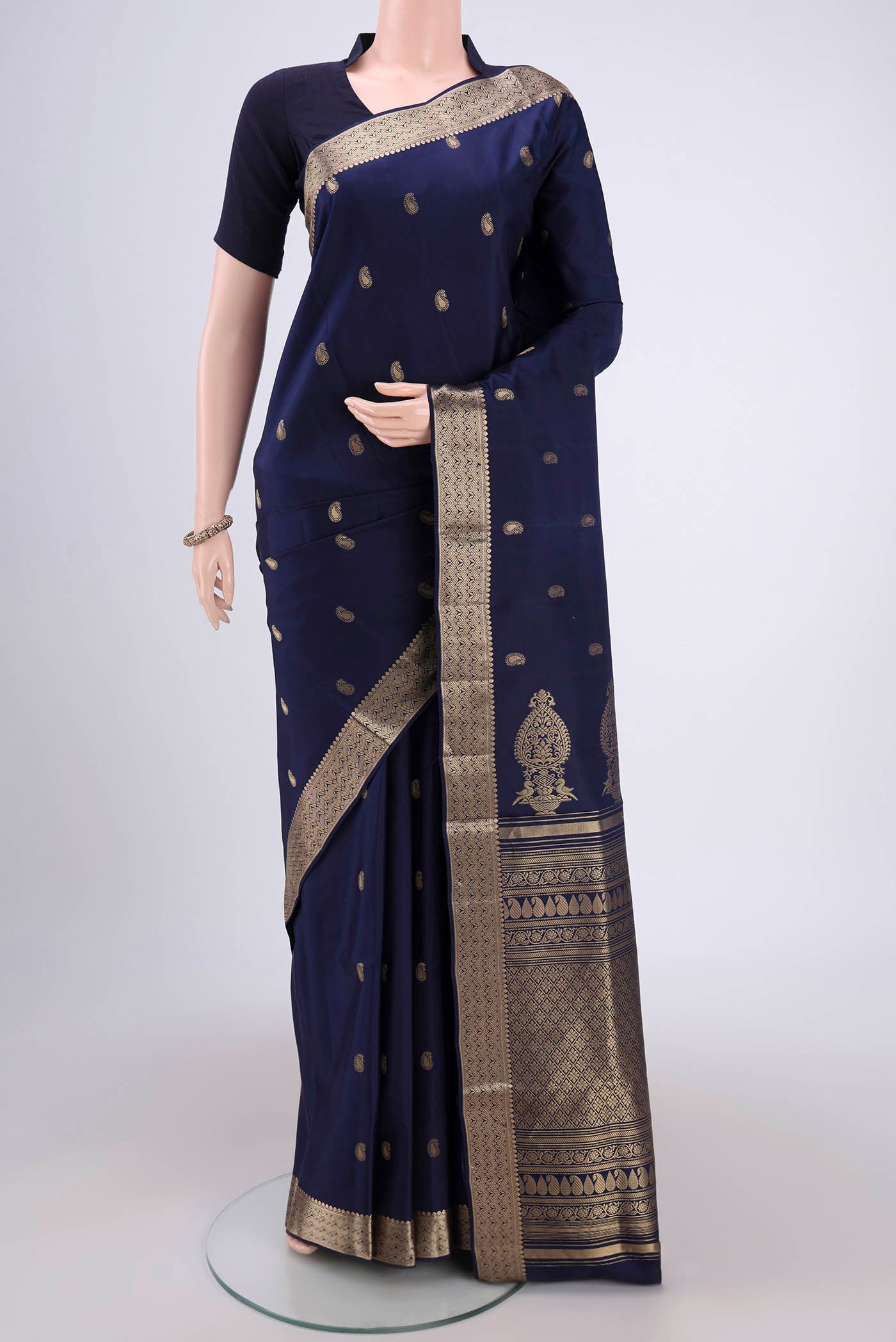 Navy Blue Soft Silk Saree with Zari Butta on the body and Zari Border.  displayed on a mannequin