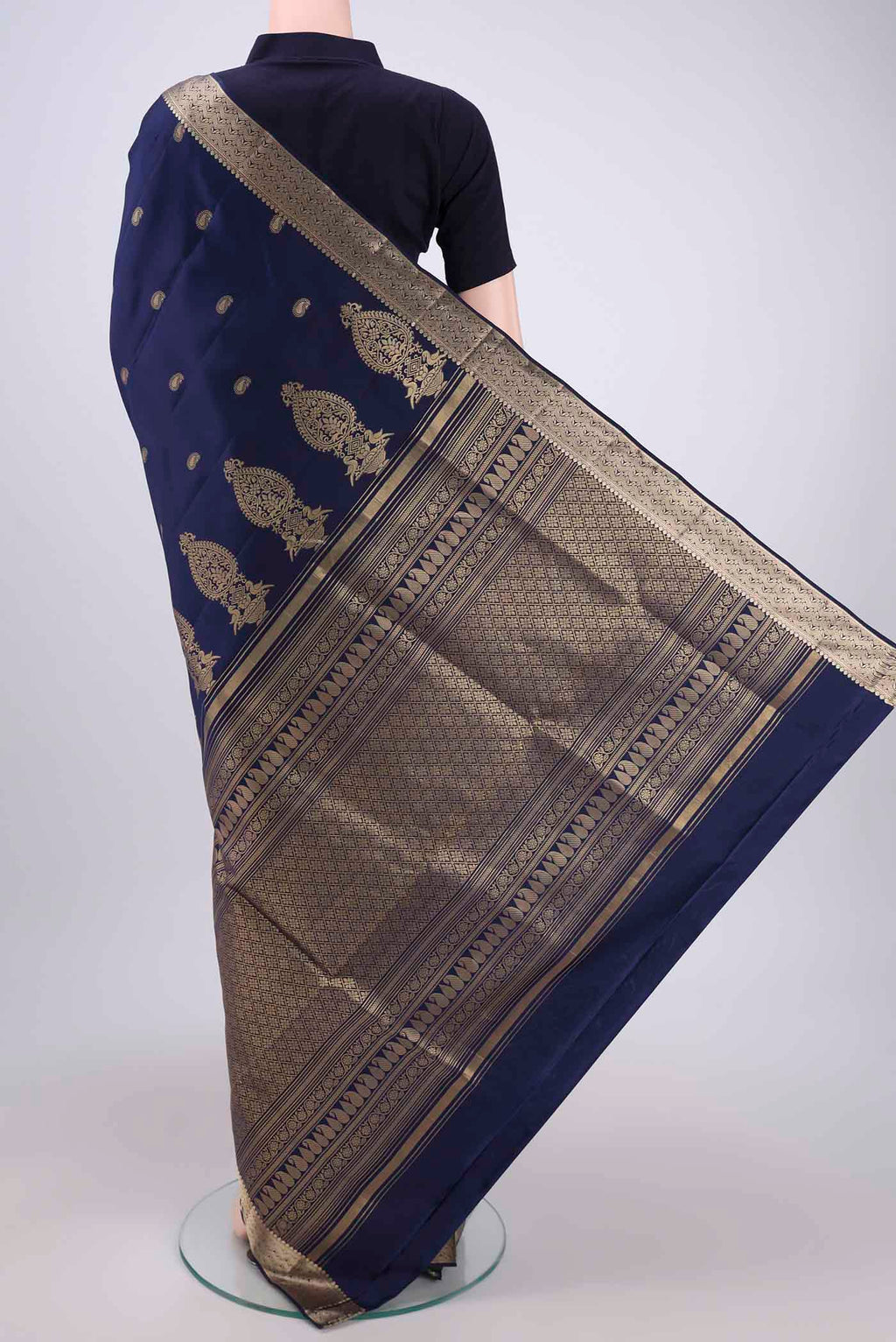 Flat view of Navy Blue Soft Silk Saree with Zari Butta on the body and Zari Border. 