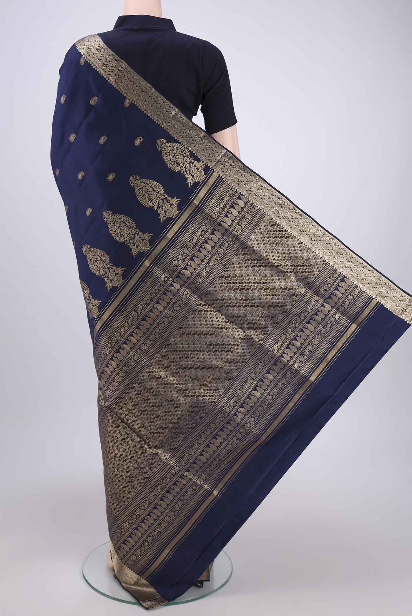 Flat view of Navy Blue Soft Silk Saree with Zari Butta on the body and Zari Border. 