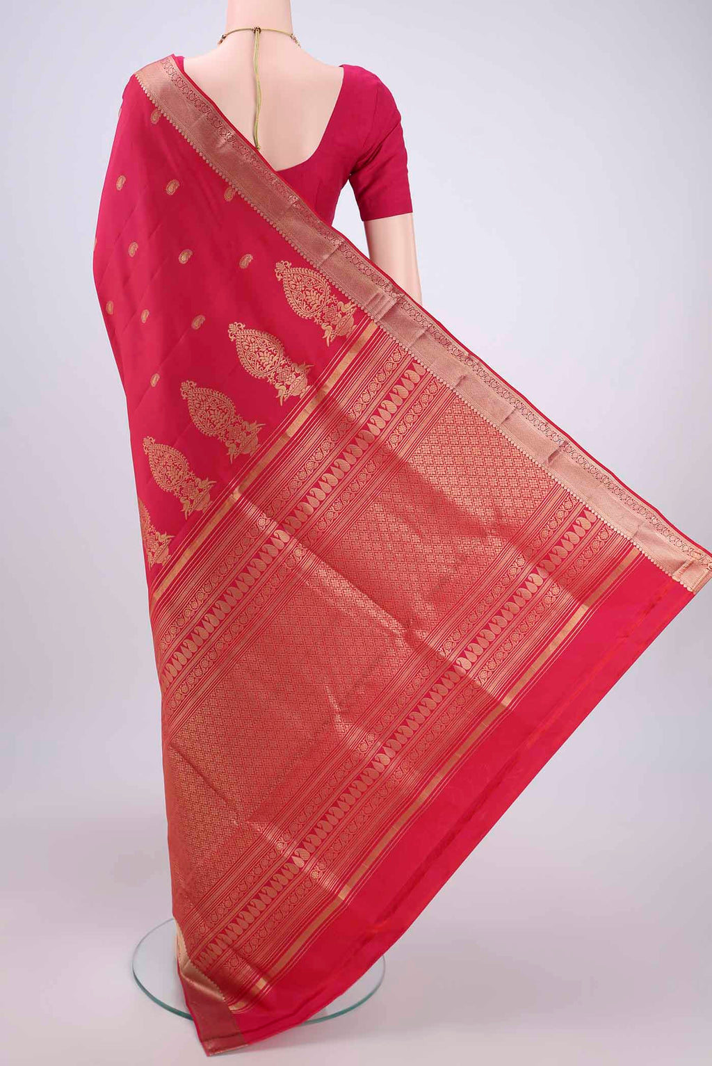 Flat view of Pink Soft Silk Saree with Zari Butta on the body and Zari Border. 
