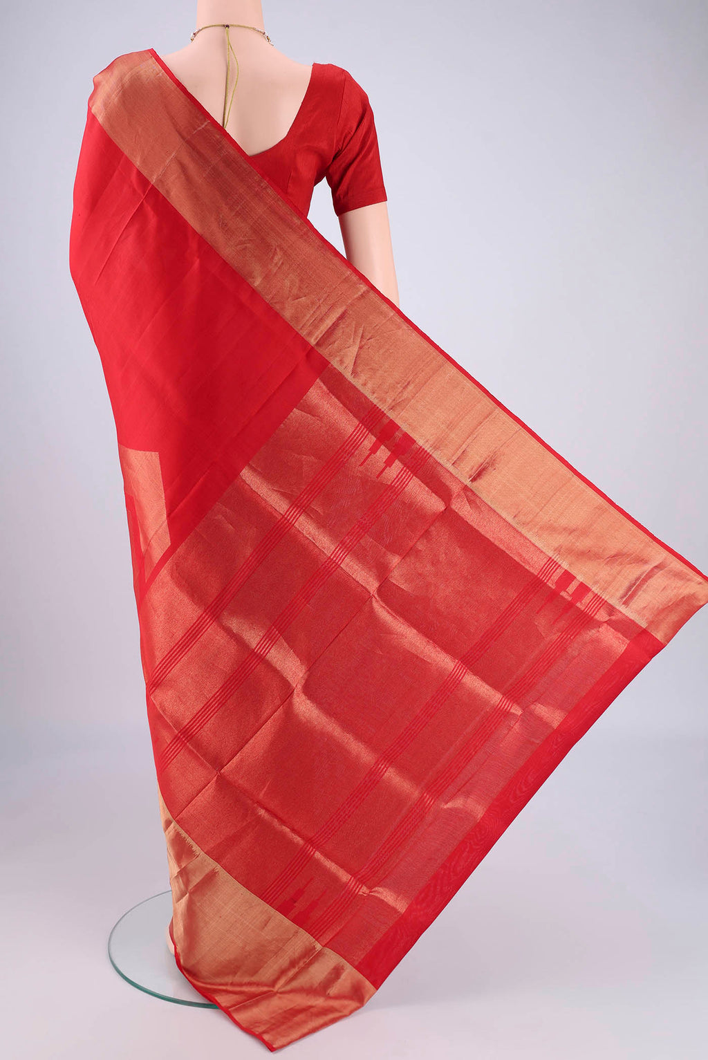 Flat view of Red Soft Silk Saree with Zari Butta on the body and Zari Border. 