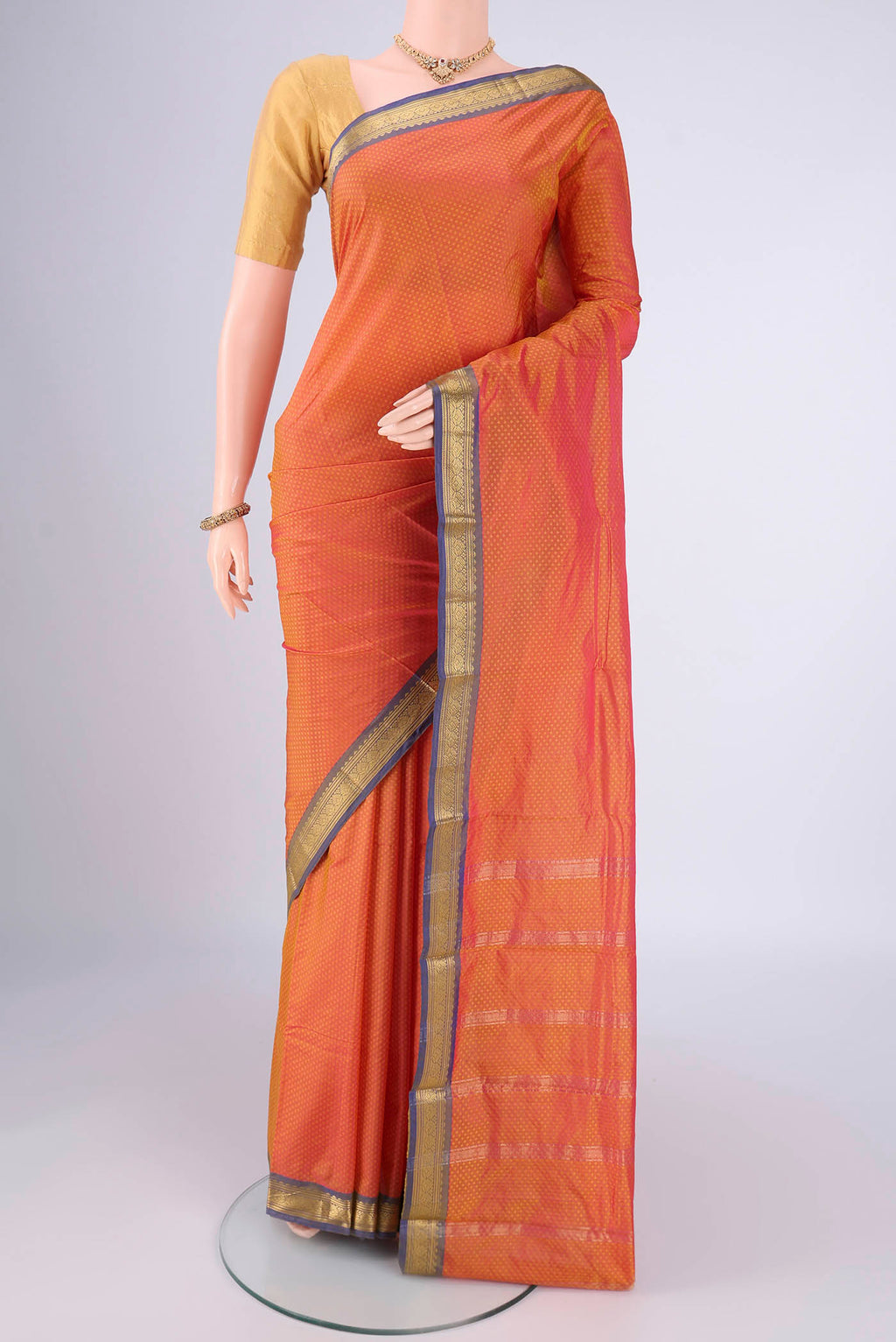 Brick Orange Blended Bangalore Silk Saree with Jacquard design on the body and Zari Border.  displayed on a mannequin