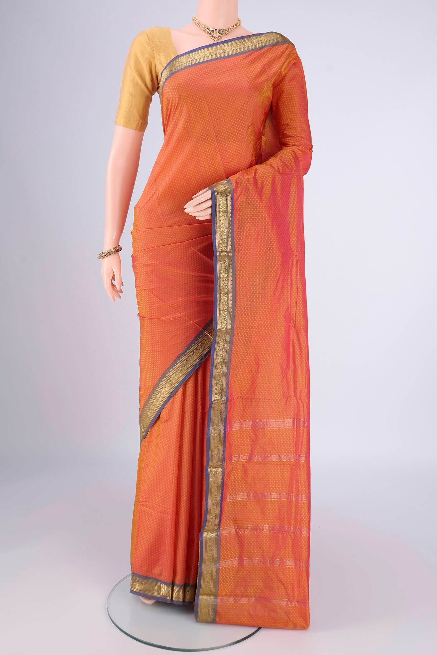 Brick Orange Blended Bangalore Silk Saree with Jacquard design on the body and Zari Border.  displayed on a mannequin