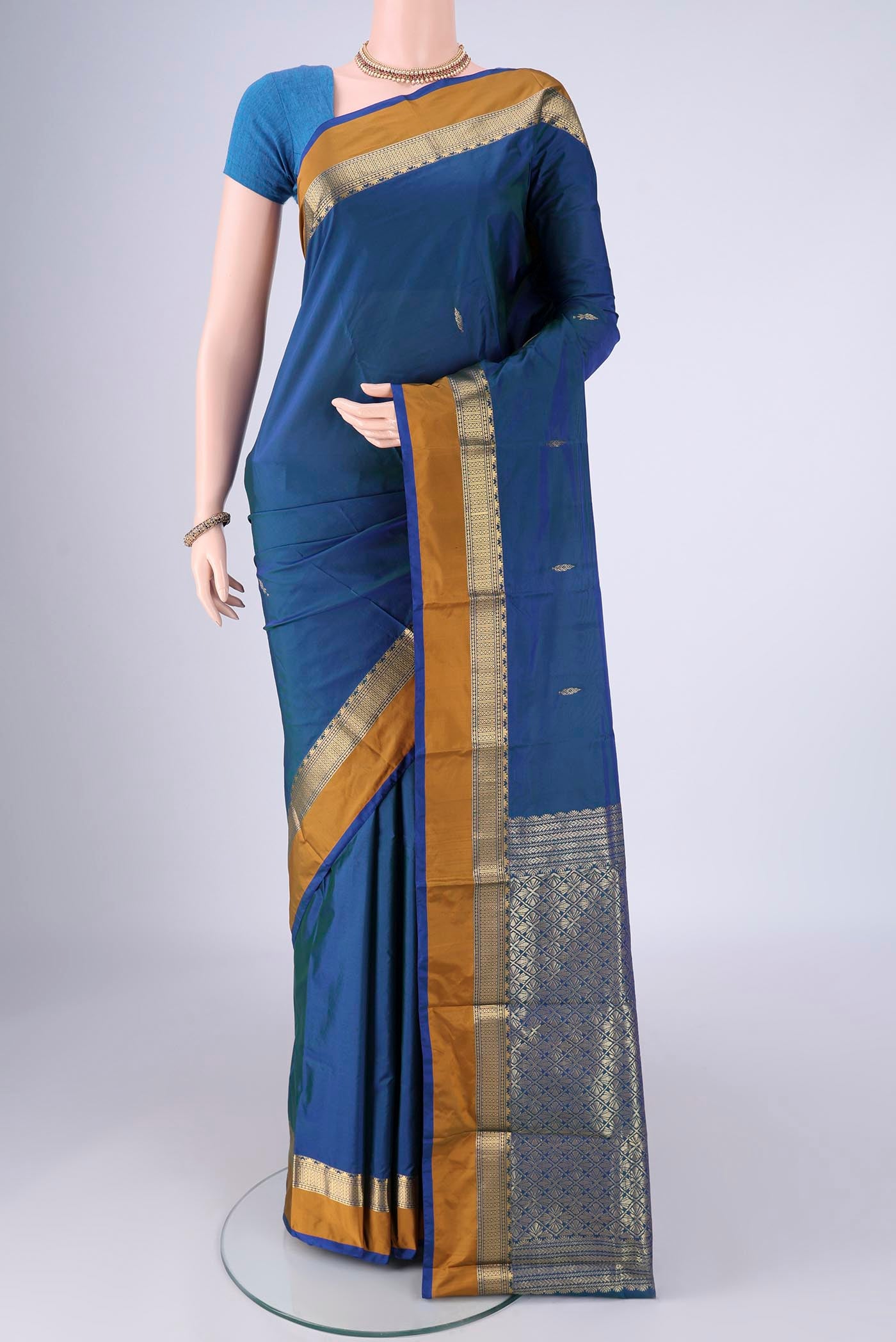 Peacock Blue Dual Tone Blended Bangalore Silk Saree with Zari Butta on the body and Zari Border.  displayed on a mannequin
