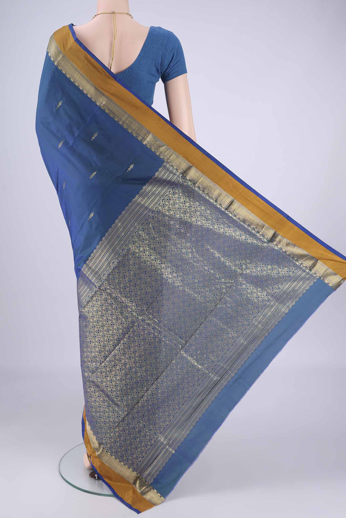 Flat view of Peacock Blue Dual Tone Blended Bangalore Silk Saree with Zari Butta on the body and Zari Border. 