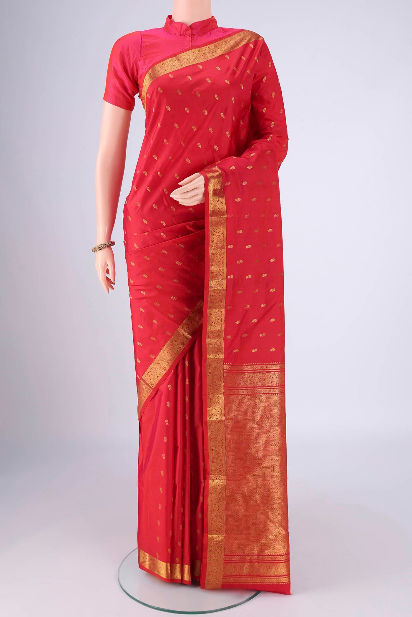 Red Dual Tone Kanchipuram Saree with Zari Butta on the body and Zari Border.  displayed on a mannequin