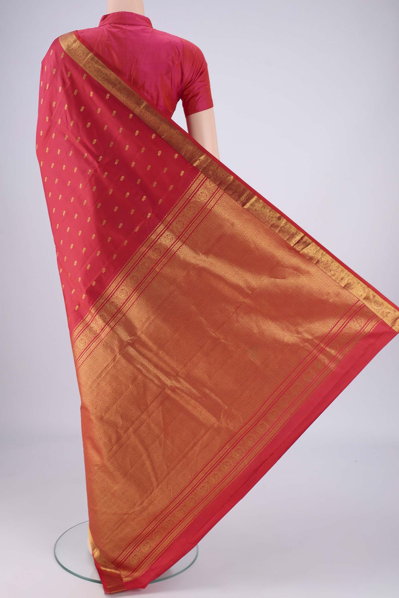 Flat view of Red Dual Tone Kanchipuram Saree with Zari Butta on the body and Zari Border. 