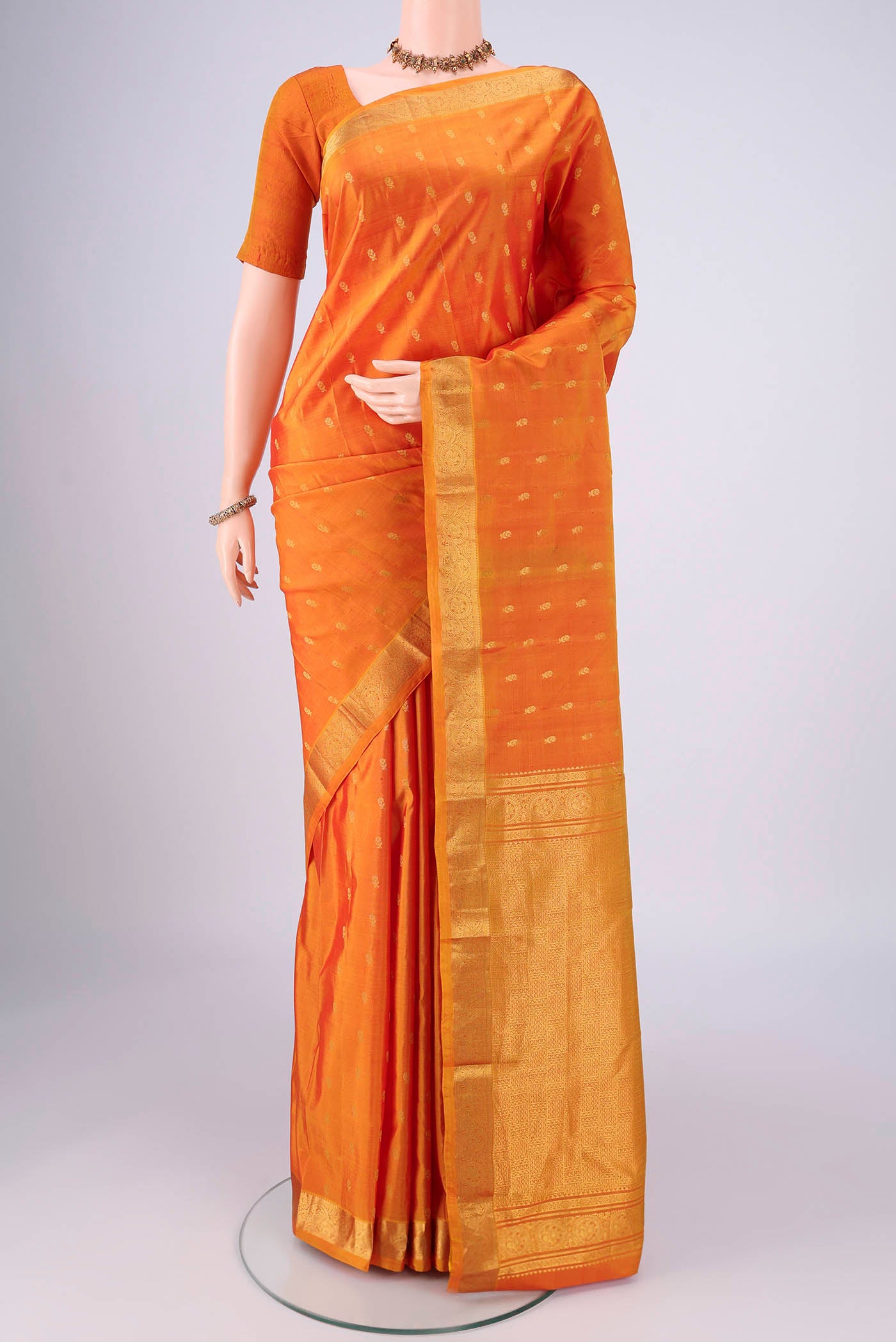 Yellow Nangavalli Silk [ Salem ] Saree with Zari Butta on the body and Zari Border.  displayed on a mannequin