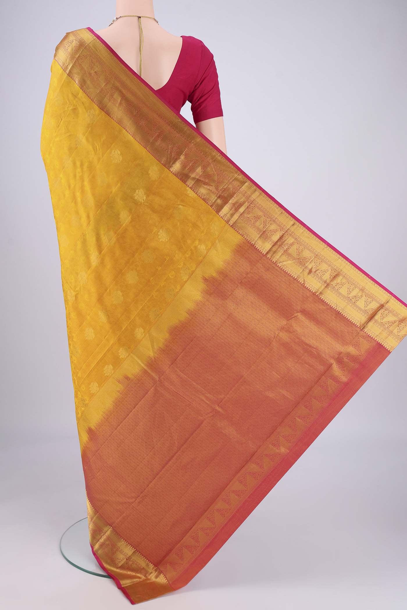 Flat view of Yellow Kanchipuram Silk Saree with Jacquard design on the body and Zari Border. 