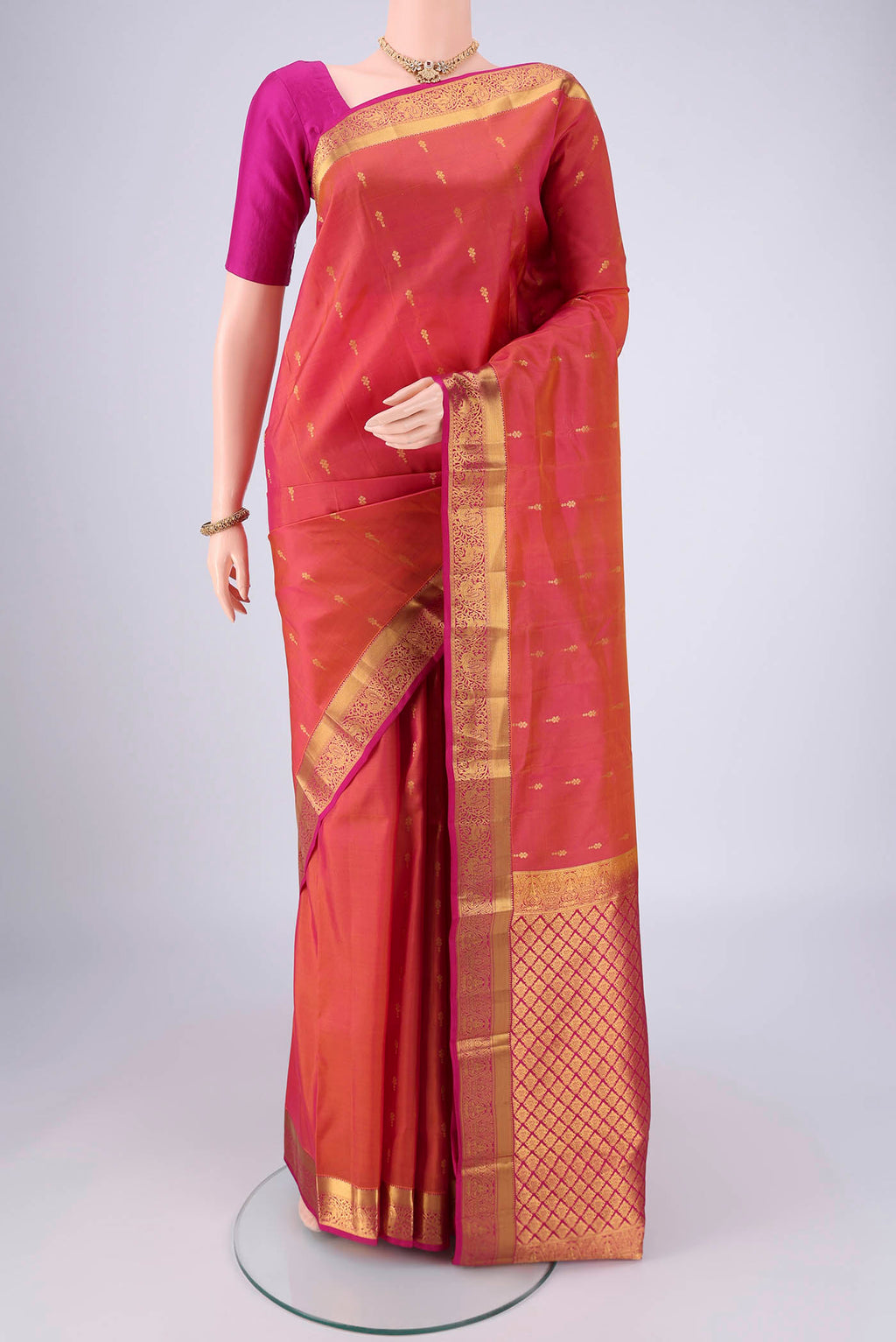 Pinkish Yellow Nangavalli Silk [ Salem ] Saree with Zari Butta on the body and Zari Border.  displayed on a mannequin