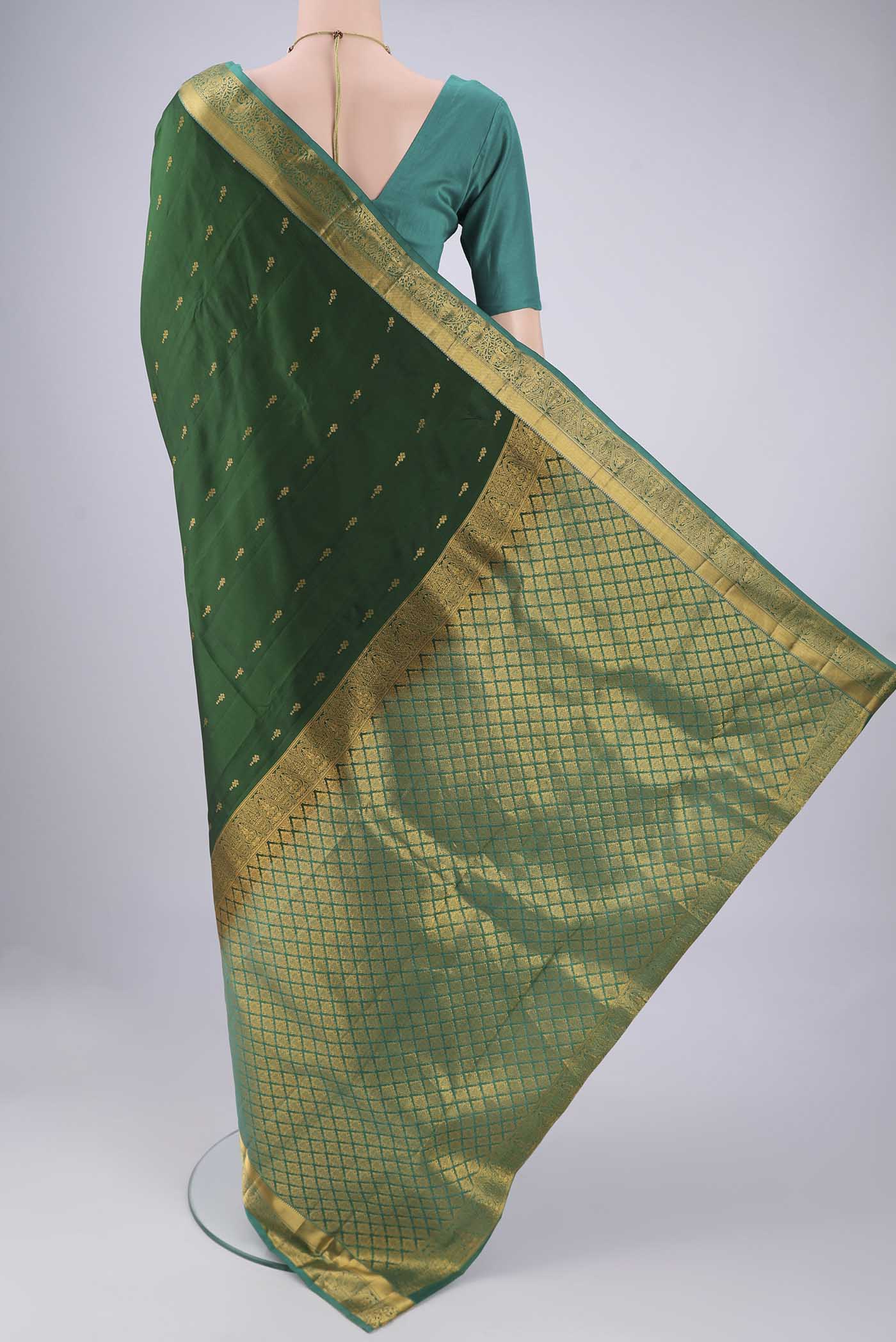 Flat view of Bottle Green Nangavalli Silk [ Salem ] Saree with Zari Butta on the body and Zari Border. 