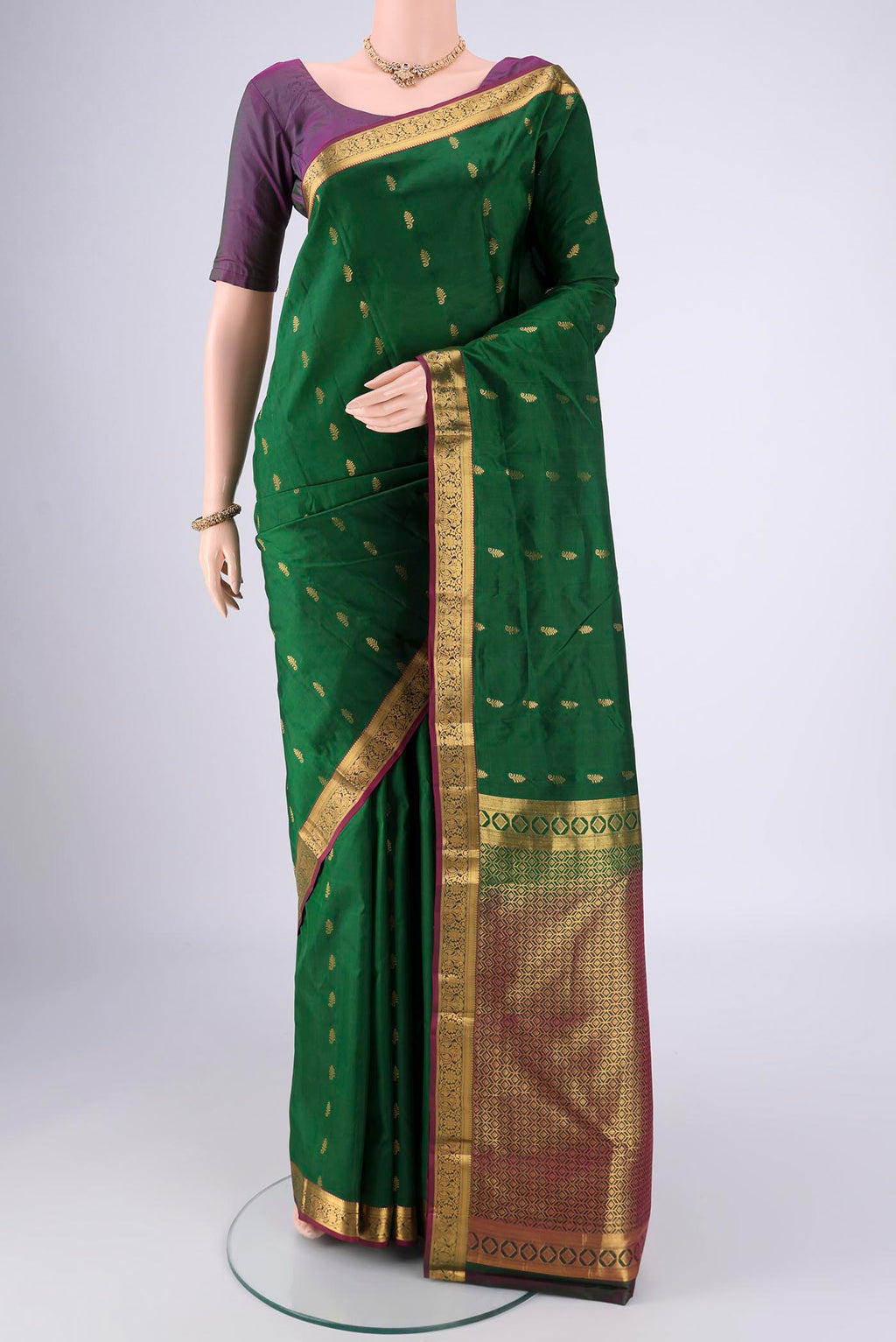 Bottle Green Nangavalli Silk [ Salem ] Saree with Zari Butta on the body and Zari Border.  displayed on a mannequin