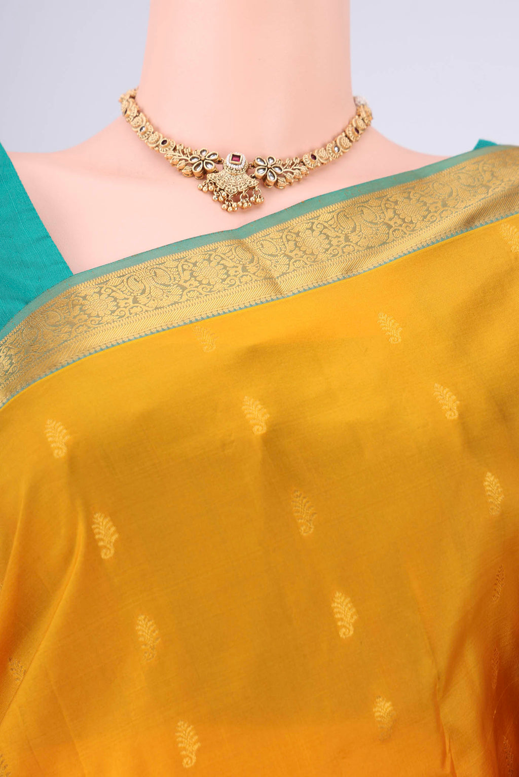 Border image of Mustard Kanjivaram Silk Saree with Zari Butta on the body and Zari Border. 