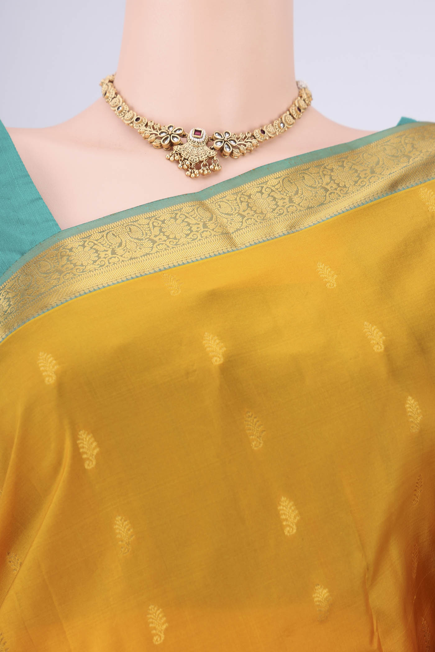 Border image of Mustard Kanjivaram Silk Saree with Zari Butta on the body and Zari Border. 