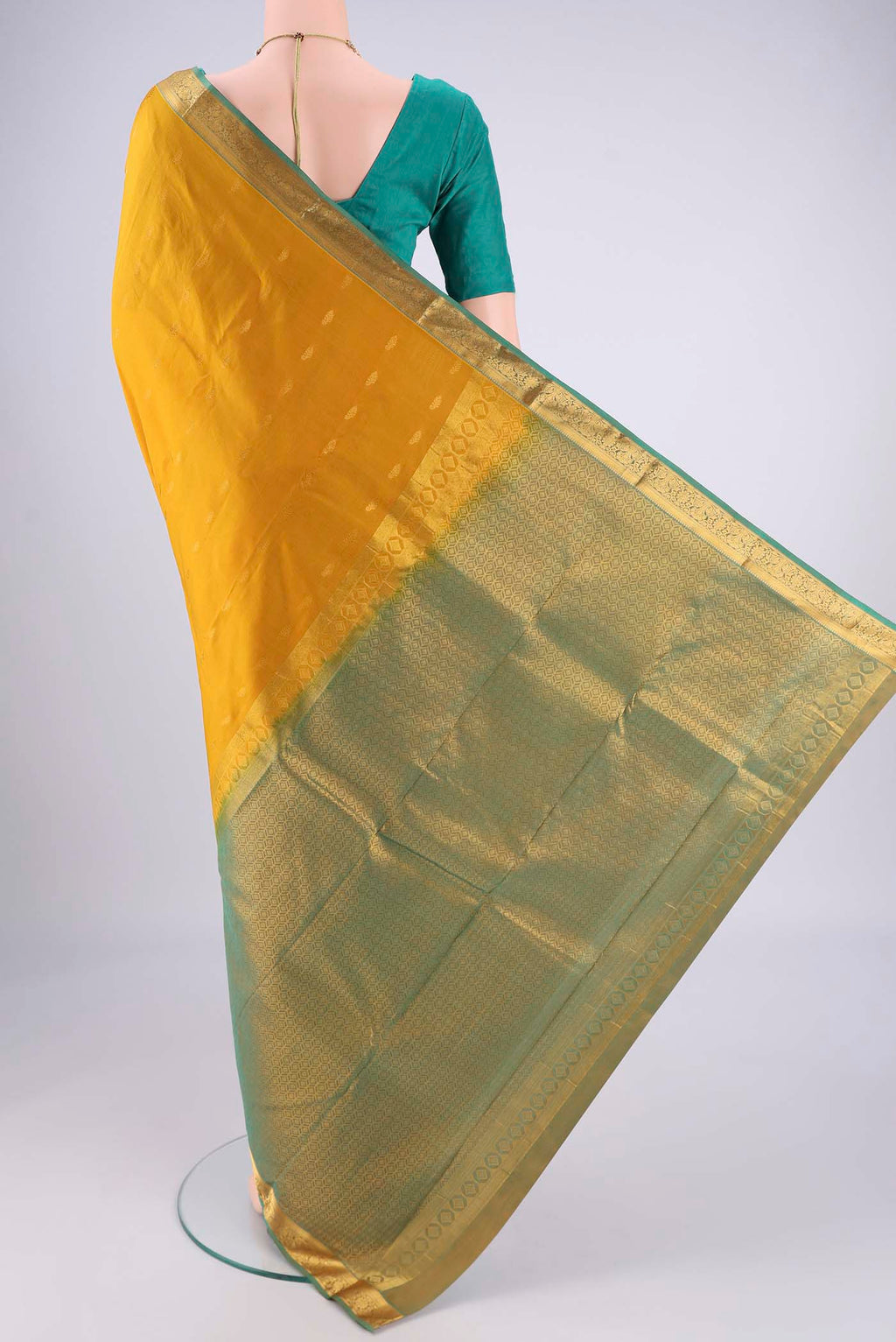 Flat view of Mustard Kanjivaram Silk Saree with Zari Butta on the body and Zari Border. 