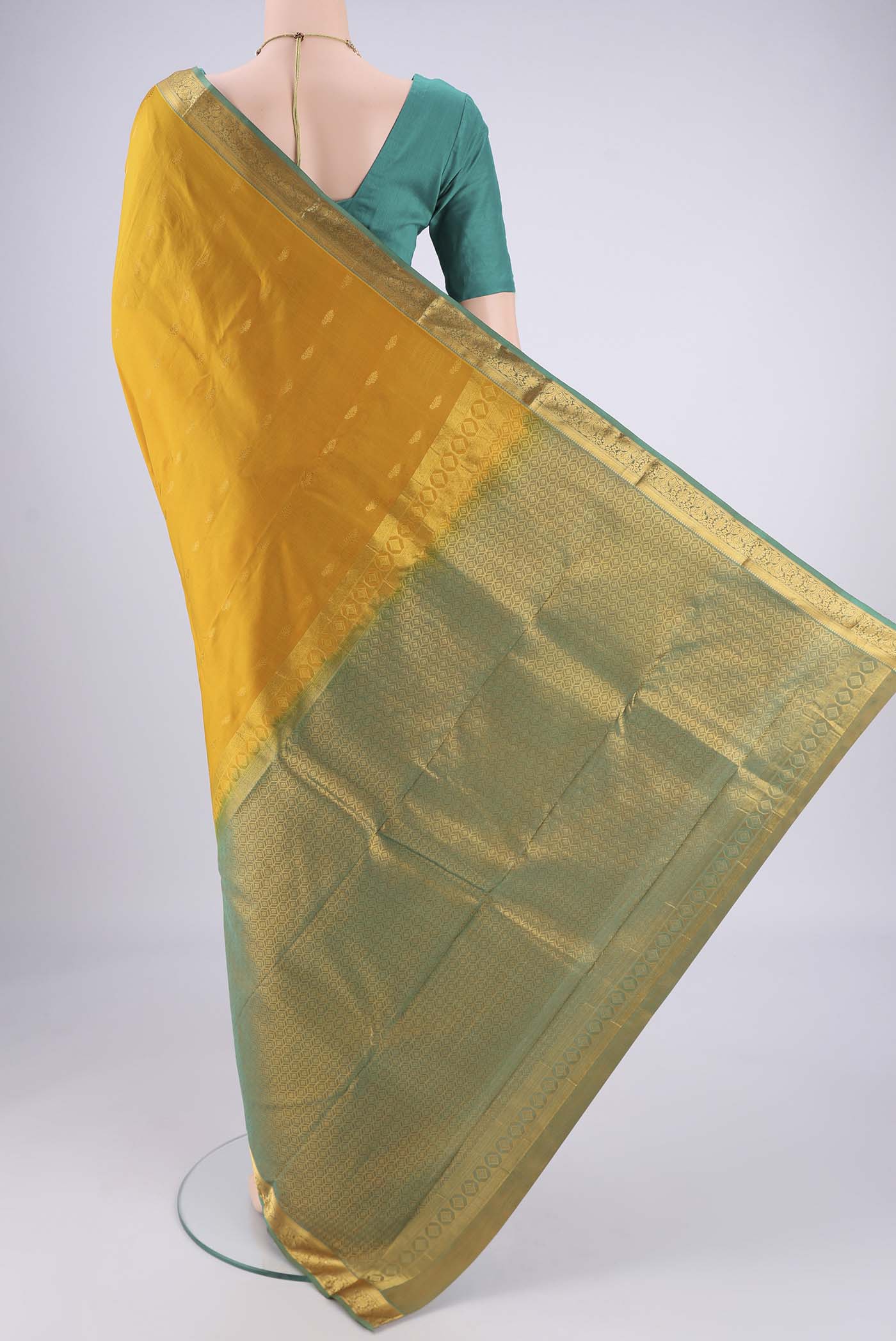 Flat view of Mustard Kanjivaram Silk Saree with Zari Butta on the body and Zari Border. 
