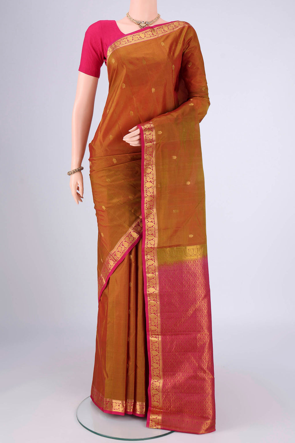Mehandi Green Dual Tone Kanjivaram Silk Saree with Zari Butta on the body and Zari Border.  displayed on a mannequin