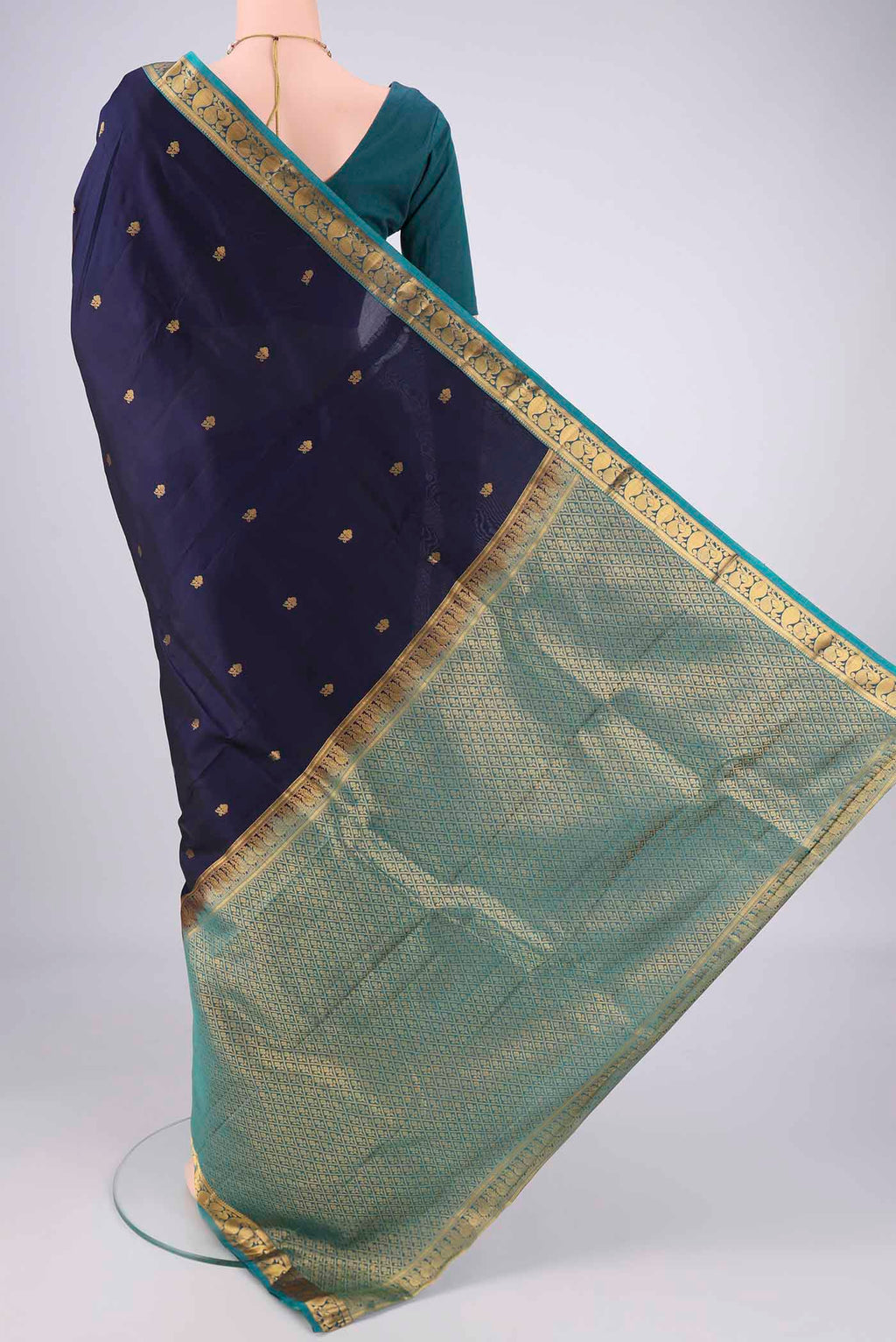 Flat view of Navy Blue Kanjivaram Silk Saree with Zari Butta on the body and Zari Border. 