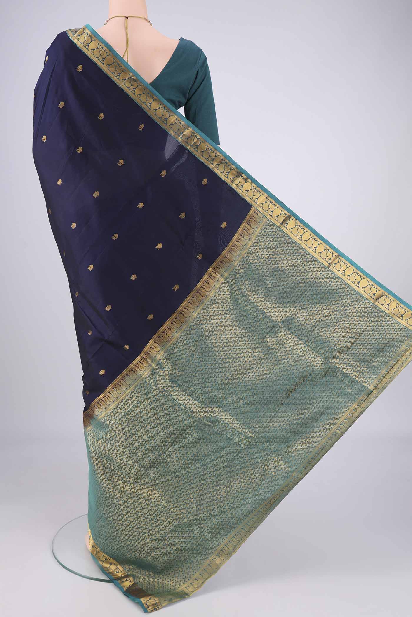 Flat view of Navy Blue Kanjivaram Silk Saree with Zari Butta on the body and Zari Border. 