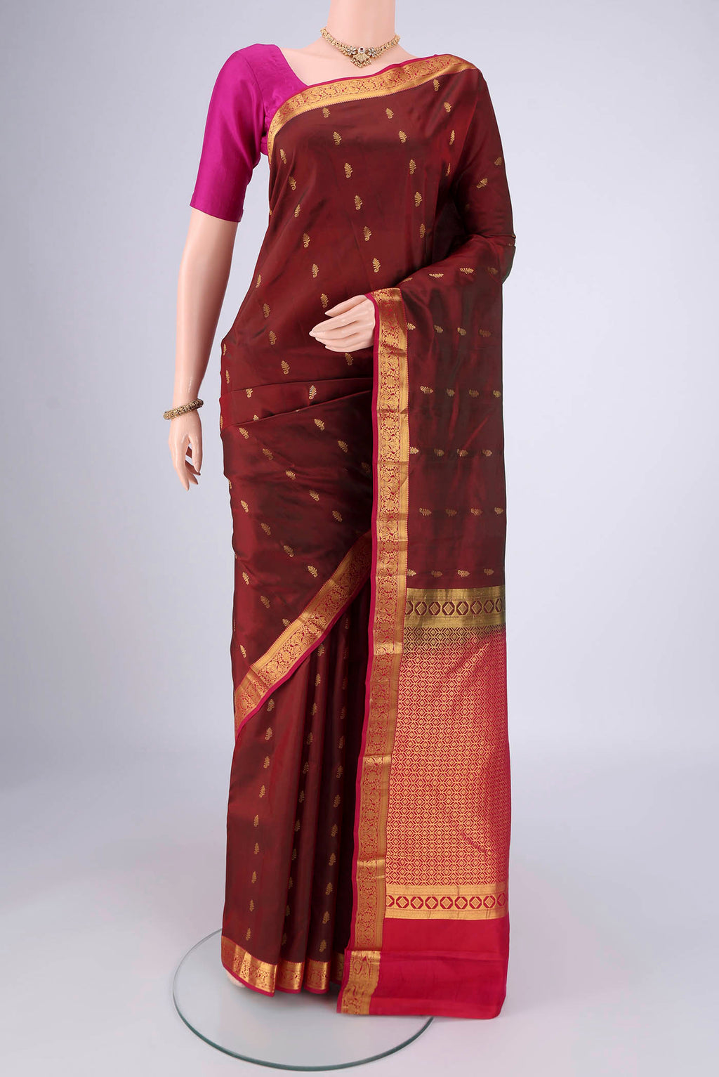 Maroon Nangavalli Silk [ Salem ] Saree with Zari Butta on the body and Zari Border.  displayed on a mannequin