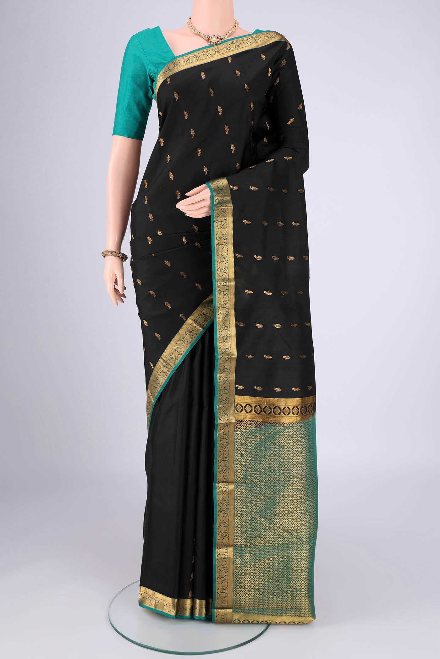 Black Nangavalli Silk [ Salem ] Saree with Zari Butta on the body and Zari Border.  displayed on a mannequin