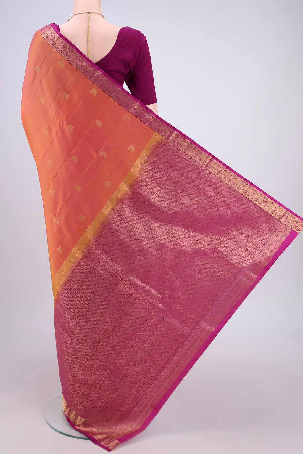 Flat view of Brick Orange Kanjivaram Silk Saree with Zari Butta on the body and Zari Border. 