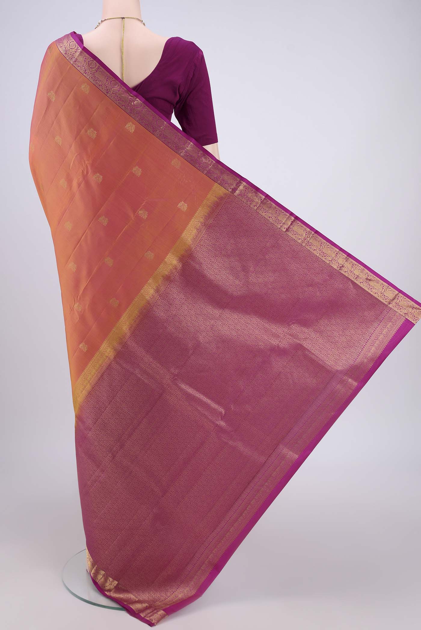 Flat view of Brick Orange Kanjivaram Silk Saree with Zari Butta on the body and Zari Border. 