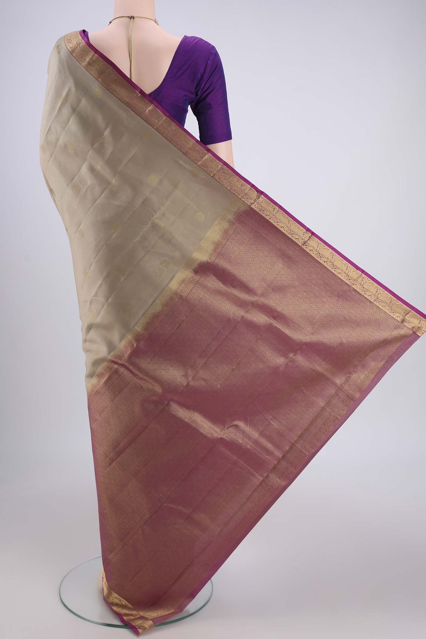 Flat view of Beige Dual Tone Kanjivaram Silk Saree with Zari Butta on the body and Zari Border. 