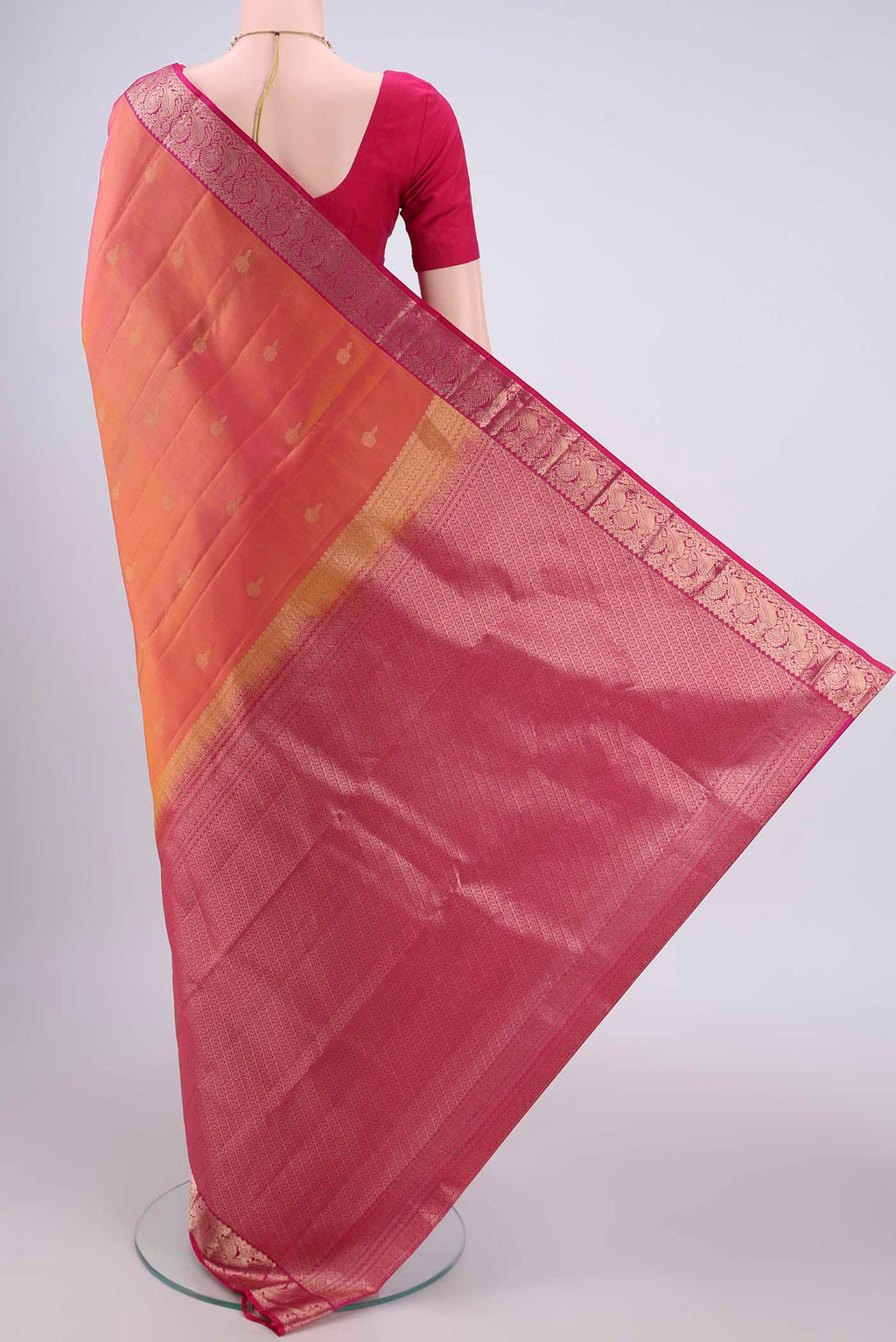 Flat view of Brick Orange Kanjivaram Silk Saree with Zari Butta on the body and Zari Border. 