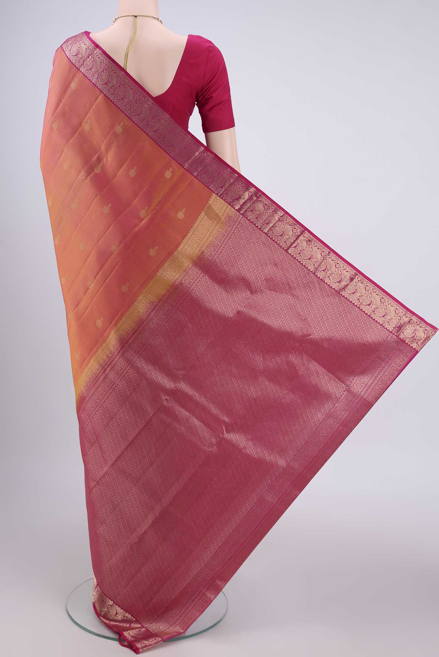 Flat view of Brick Orange Kanjivaram Silk Saree with Zari Butta on the body and Zari Border. 