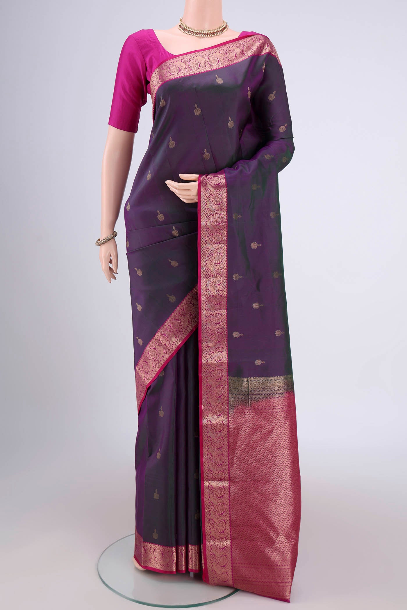 Green Dual Tone Kanjivaram Silk Saree with Zari Butta on the body and Zari Border.  displayed on a mannequin