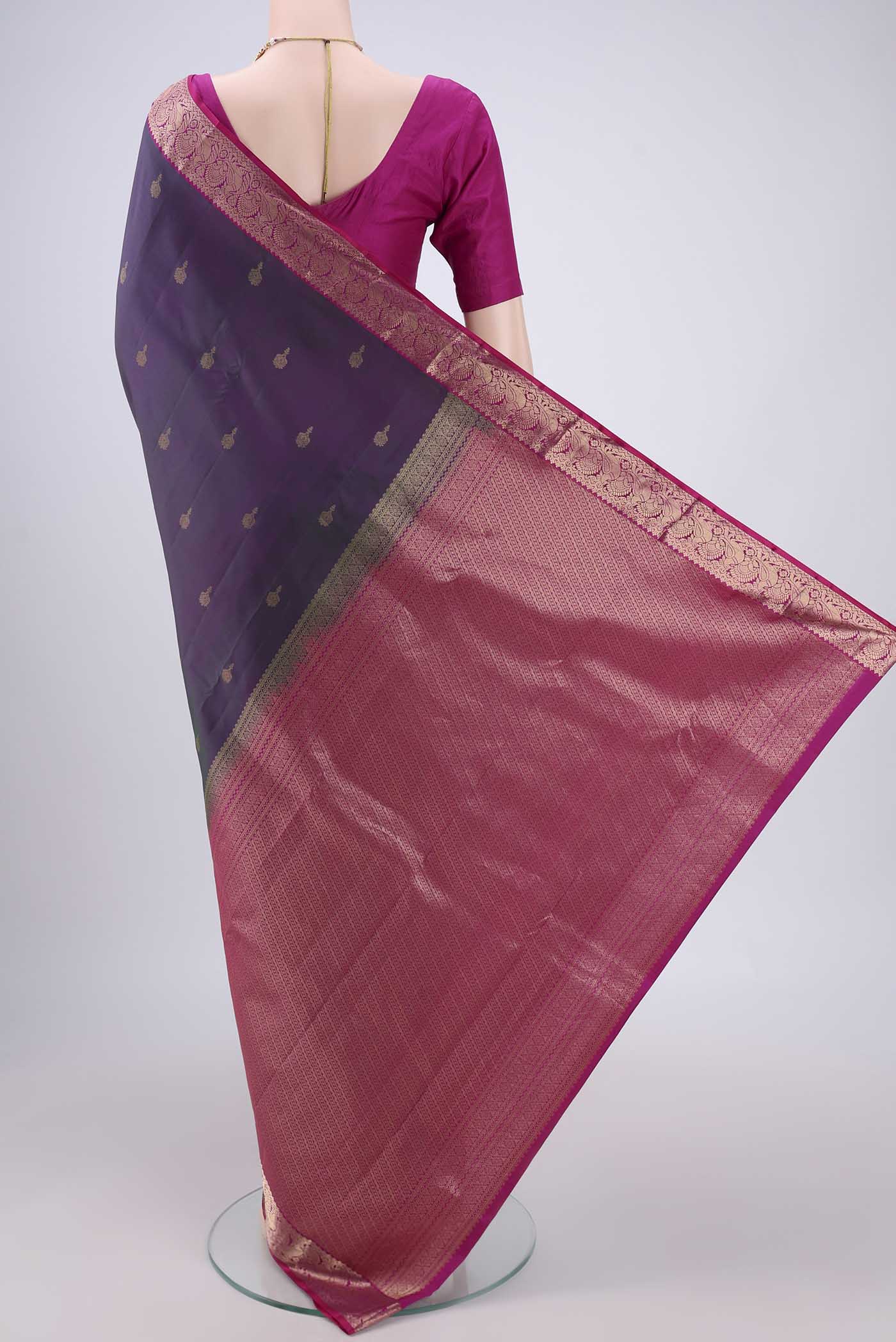 Flat view of Green Dual Tone Kanjivaram Silk Saree with Zari Butta on the body and Zari Border. 