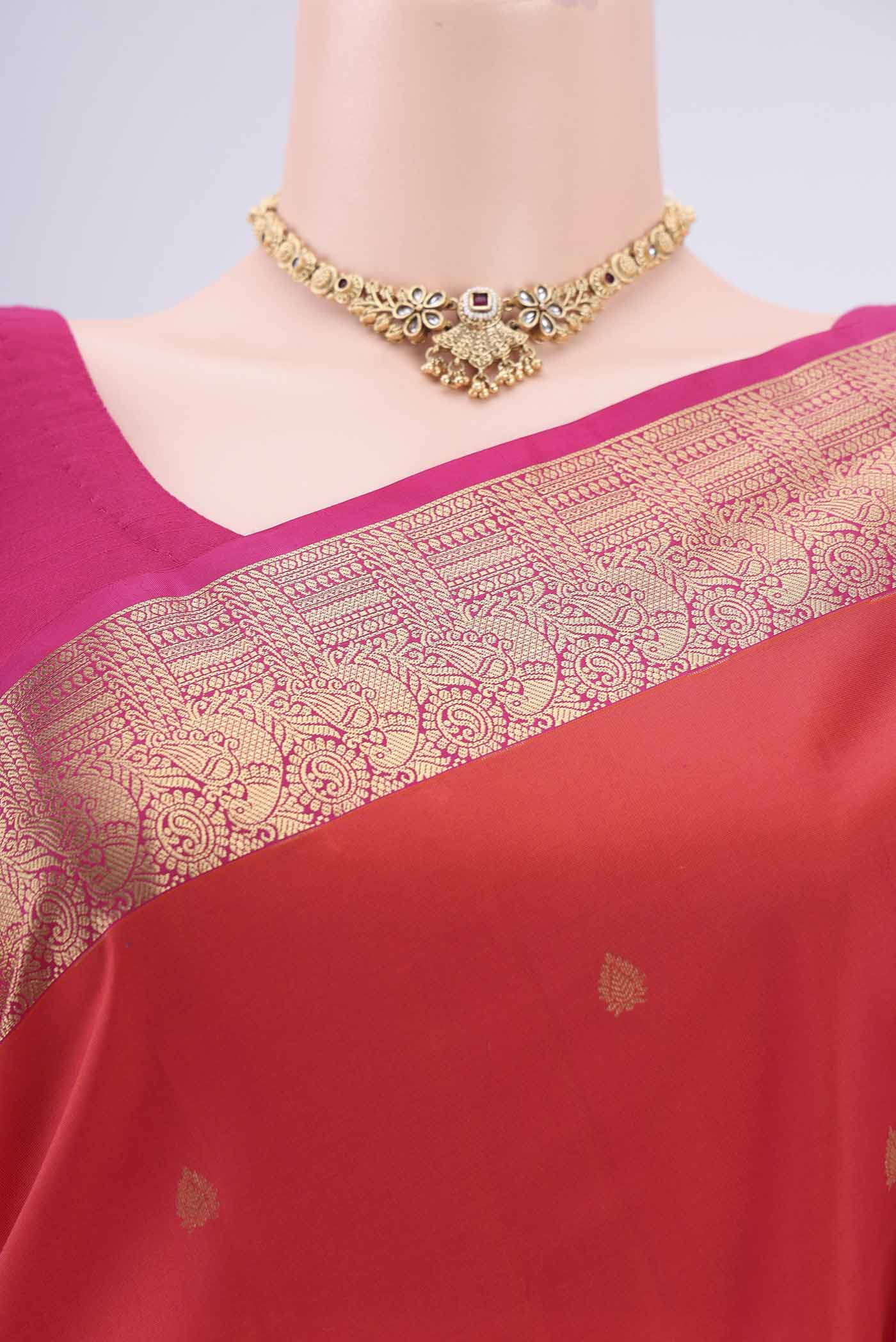 Border image of Orange Kanchipuram Silk Saree with Zari Butta on the body and Zari Border. 