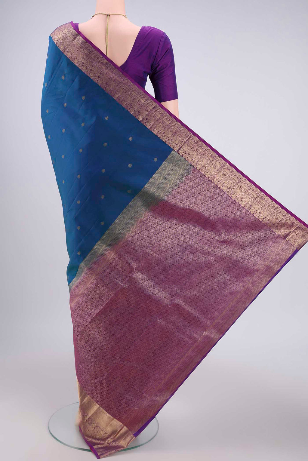 Flat view of Peacock Blue Dual Tone Kanchipuram Silk Saree with Zari Butta on the body and Zari Border. 