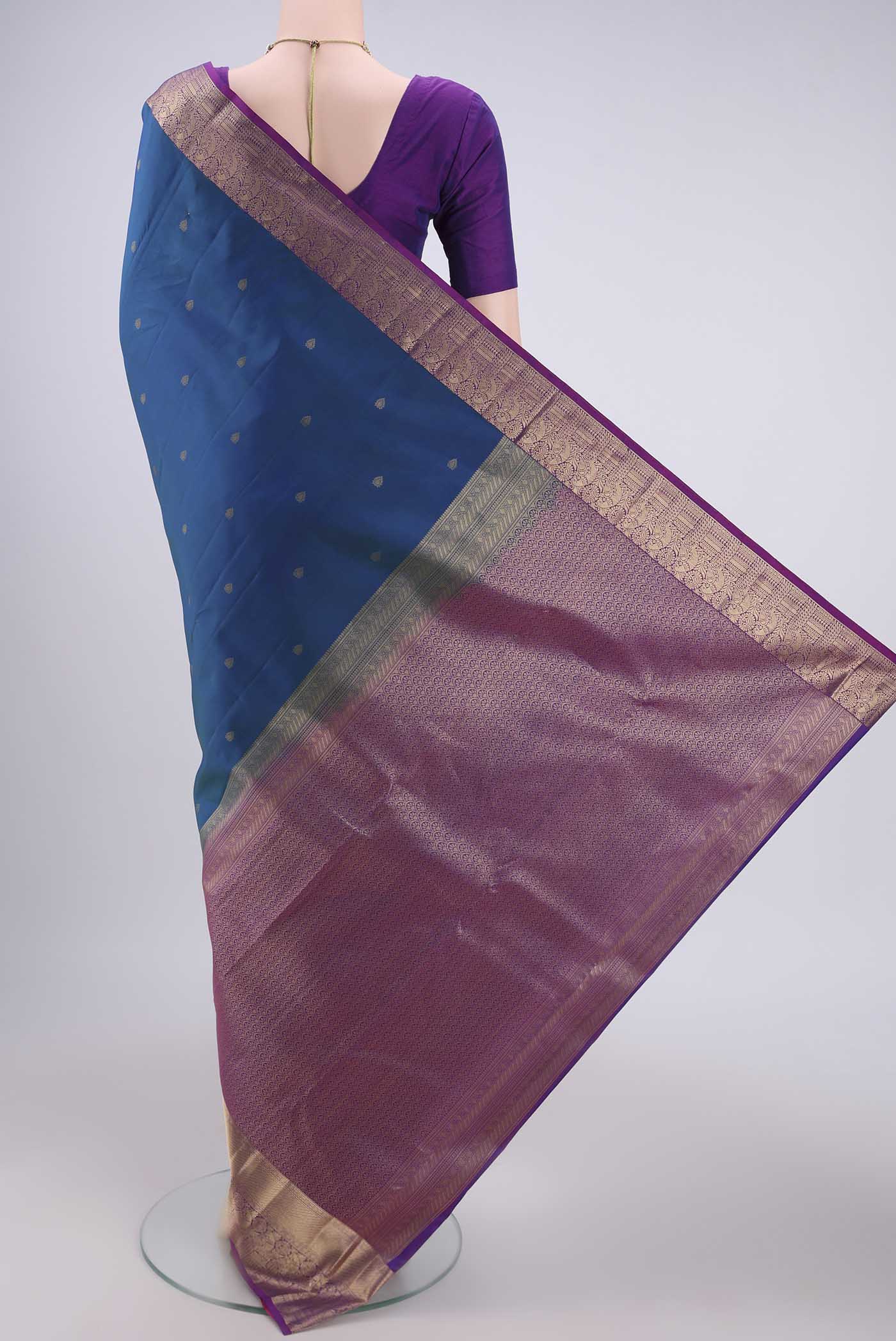 Flat view of Peacock Blue Dual Tone Kanchipuram Silk Saree with Zari Butta on the body and Zari Border. 
