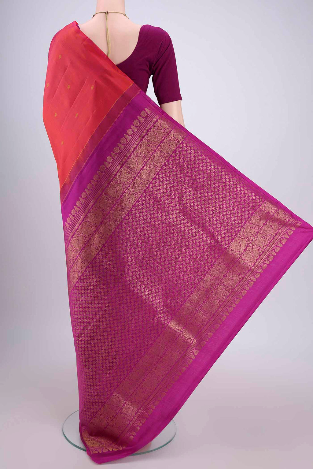 Flat view of Orange Dual Tone Kanchipuram Silk Saree with Zari Butta on the body and Attached Border. 
