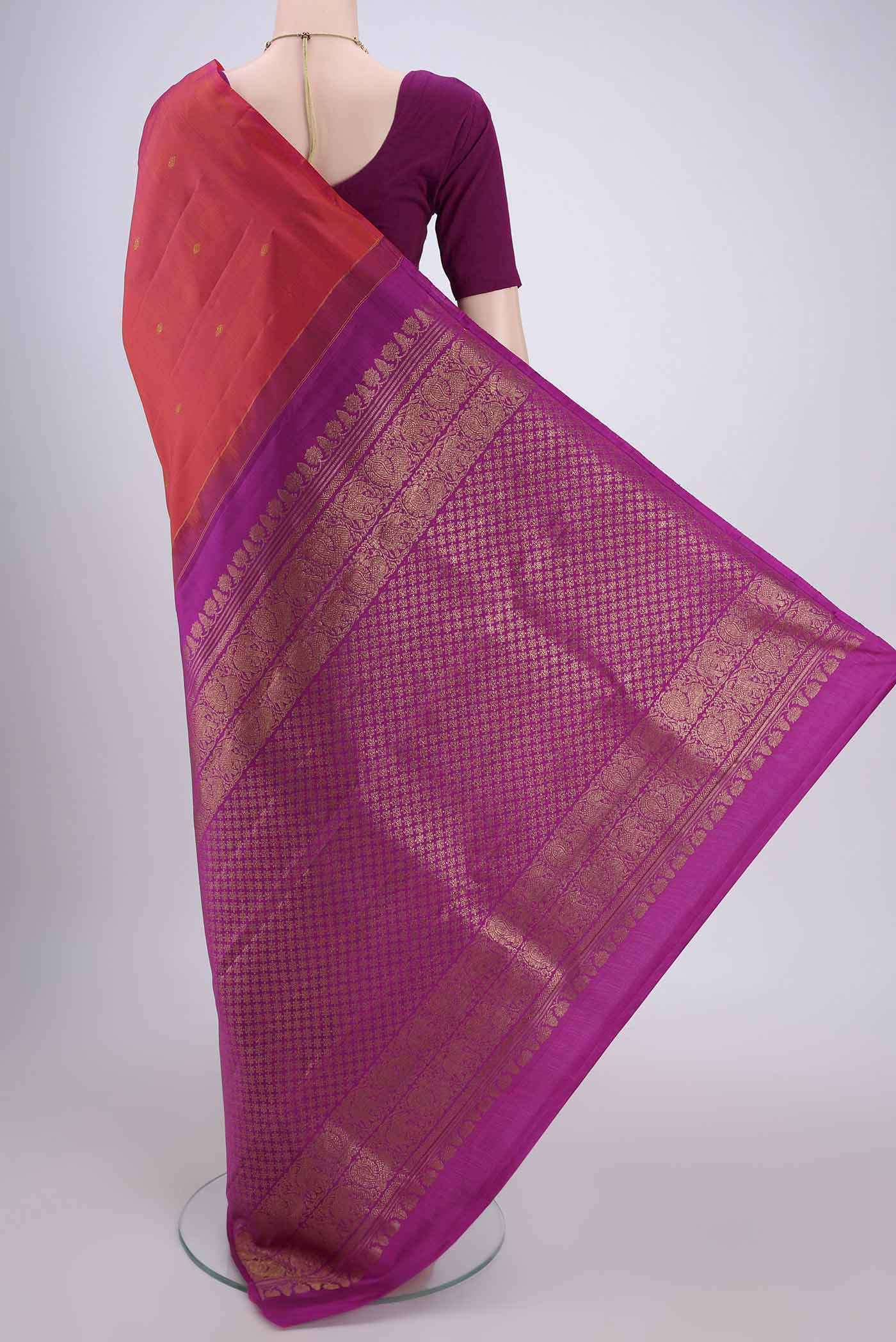 Flat view of Orange Dual Tone Kanchipuram Silk Saree with Zari Butta on the body and Attached Border. 