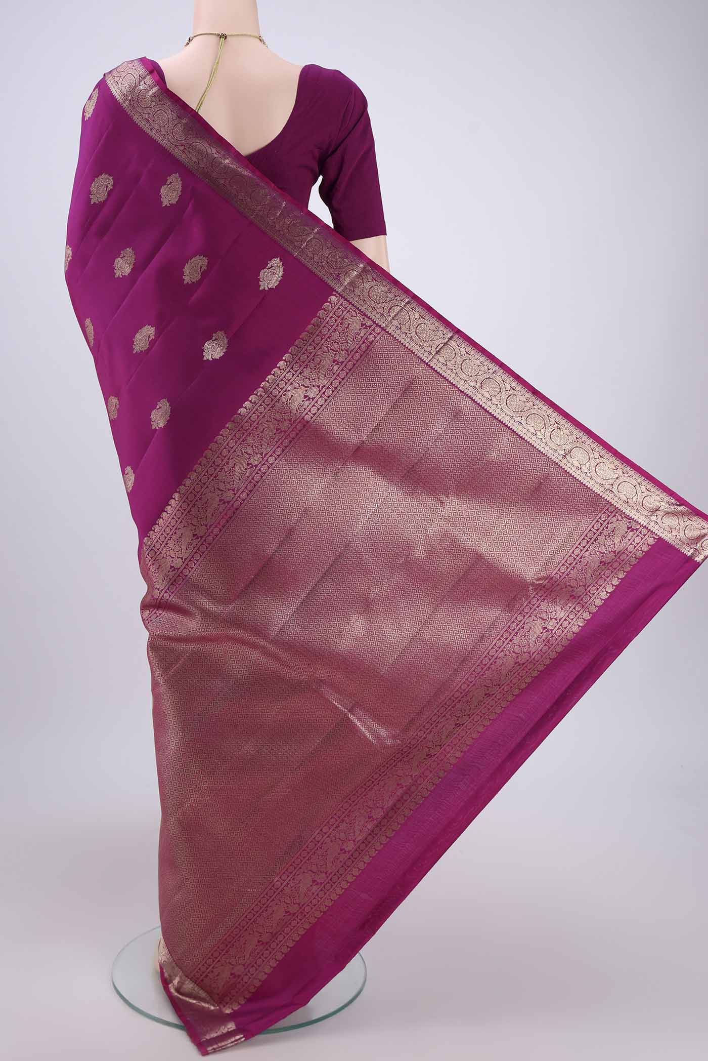 Flat view of Magenta Kanjivaram Silk Saree with Zari Butta on the body and Zari Border. 